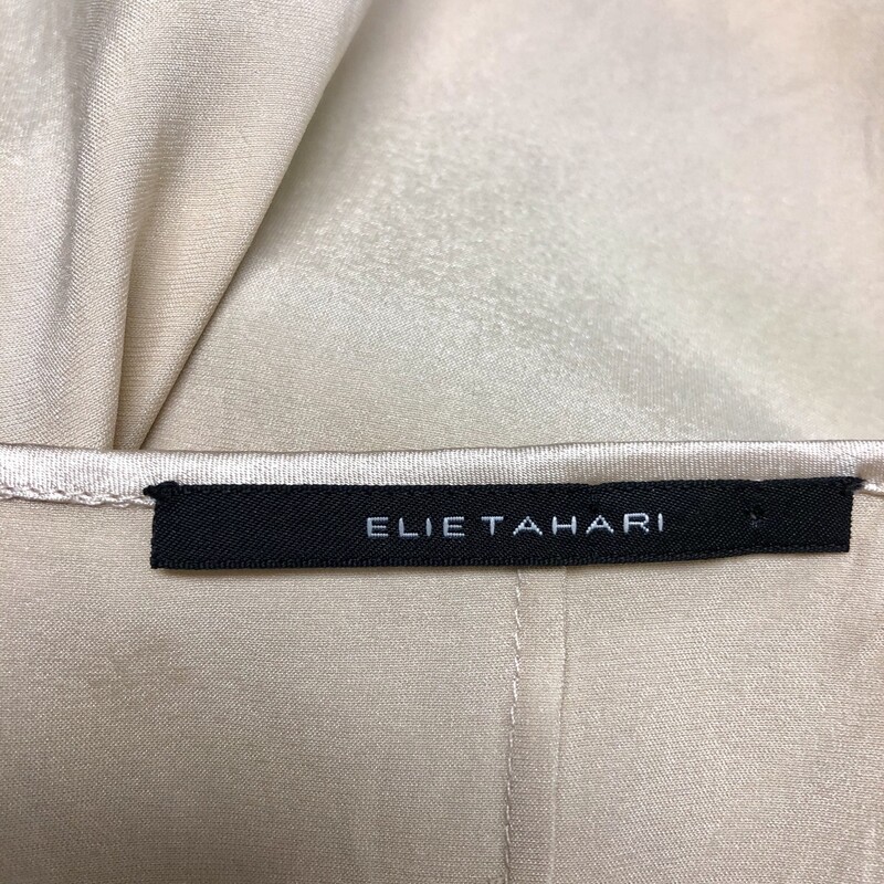 ELLIE TAHARI 2 Pc.Top Set, Beige, Size: S/P.  Blouse = 100% silk, Camisole = 94% silk, 6% elastic.  Blouse is truly so feminine, v necked, doaned with 5 tiny button accent as well as cuffs which also have a total of 11 buttons on each and are ruffled, length = appox. 24\", sleeve length = approx. 32\".  An  accent of lace trim can be seen at base of blouse with matching lace on top of inside camisole.  Blouse also has a gentle elastic strip below bustline which totally extends from front to back.  Again so unique and sheer effect is so delicate.
