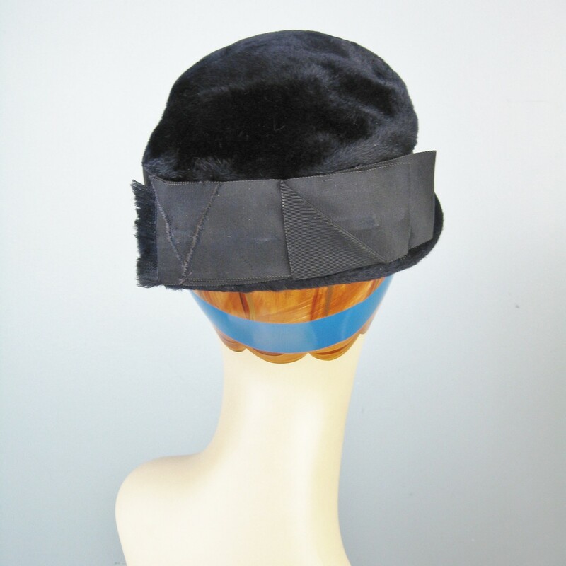 Simple winter hat in very dark navy blue fur velour from the 1950s<br />
It's basically a pillbox with a teeny brim and a wide folded grosgrain ribbon around the crown.<br />
The ribbon forms a tailored flat bow with frayed edges.<br />
<br />
Stamped  Ballet<br />
Made in Czechoslovakia<br />
<br />
Great condition, except for the ribbon being slightly discolored at the back.<br />
Inner hat band measures: 21 1/4<br />
<br />
Thanks for looking.<br />
#31262