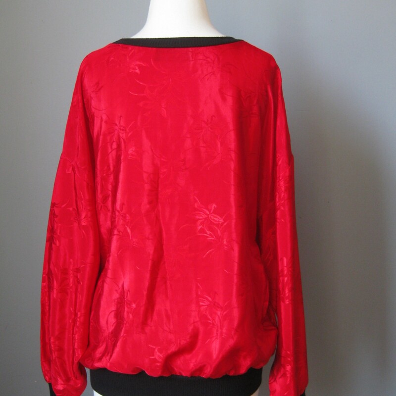 Bright red shirt from the 1980s in satin jacquard<br />
<br />
Black contrast trim at neck and sleeve ends<br />
<br />
Made in the USA by the brand Claudia<br />
Marked size large<br />
flat measurements:<br />
armpit to armpit: 24in<br />
length: 24 3/4in<br />
<br />
excellent condition, no flaws<br />
<br />
thanks for looking!