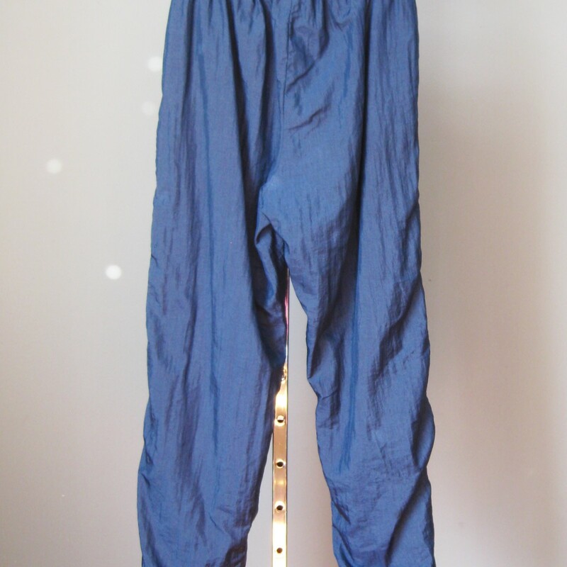 Cool Vintage Wilson nylon warm-up pants.<br />
Elastic waist<br />
Elastic cuffs with zippers<br />
cotton/poly lining<br />
<br />
Marked size L<br />
Perfect condition<br />
<br />
flat measurements:<br />
waist: 13 3/4 ---> 18in<br />
rise: 16in (they hang low at the crotch)<br />
hip: 26in<br />
inseam: 30in<br />
<br />
<br />
Thanks for looking!