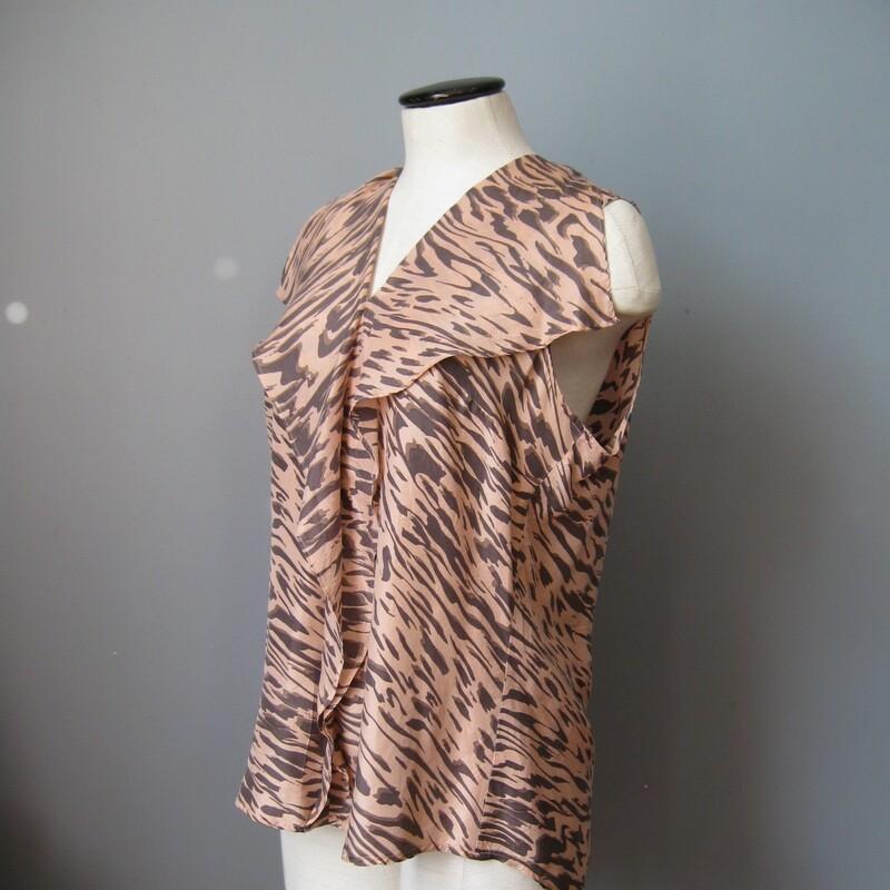 Pullover top from CAbi with a shawl collar and ruffle down the center front<br />
Black tiger print on a peach background<br />
100% silk<br />
<br />
Size Medium<br />
armpit to armpit: 21in<br />
length: 26 3/4in<br />
<br />
perfect condition<br />
#1596