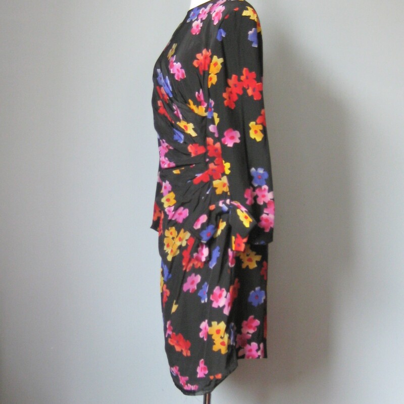 Scaasi floral silk fitted cocktail dress.<br />
Black background with multi color floral pattern<br />
The dress is shaped with ruching to the side for a very flattering silhouette<br />
Fully lined<br />
Jewel neckline<br />
Long sleeves<br />
shoulder pads<br />
Marked size 14, but it would be small for a modern size 14<br />
Flat measurements<br />
Shoulder to shoulder: 17in<br />
Armpit to Armpit: 20in<br />
Waist: 17in<br />
Hips: 20in<br />
<br />
Thank you for looking.<br />
#14219