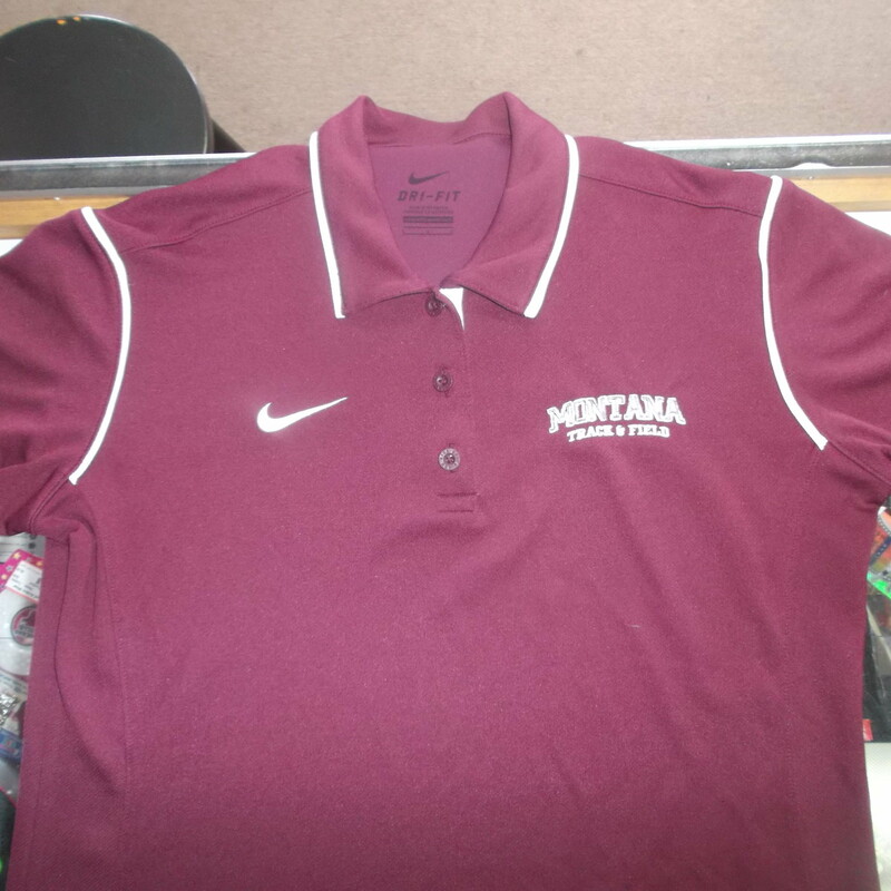 Montana Grizzlies Track & Field Women's Nike Dri Fit Polo Size Large Maroon<br />
Rating:   (see below) 3 - Good Condition<br />
Team: Montana Grizzlies<br />
Player: N/A<br />
Brand: Nike<br />
Size: Large - Women's(Measured Flat: Across chest 19\"; length 27\") measurements are from armpit to armpit and from shoulder to hem; - please check measurements. <br />
Color: Maroon<br />
Style: Short sleeve polo shirt; Embroidered logo<br />
Material:  100% Polyester<br />
Condition: - Good Condition - wrinkled; Material looks and feels good; Some snags throughout the front; Light fuzz; Signs of use; No noticeable stains, rips, or holes(See Photos)<br />
Shipping: $3.37