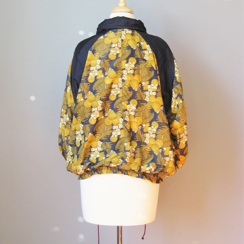 Navy Blue & gold fall floral print bomber jacket from the 1980s by Great Gear Clothing Co.<br />
High funnel neck<br />
elasticized waist and cuffs<br />
Shell is 100% nylon<br />
Fully lined in poly cotton blend<br />
Shoulder pads<br />
zipper Pockets<br />
Drawstring hip<br />
made in Pakistan<br />
Markeed size small but should fit almost anyone!<br />
flat measurements:<br />
armpit to armpit: 24in<br />
length: 26in<br />
shoulder to shoulder: 17in<br />
thanks for looking!<br />
#14550