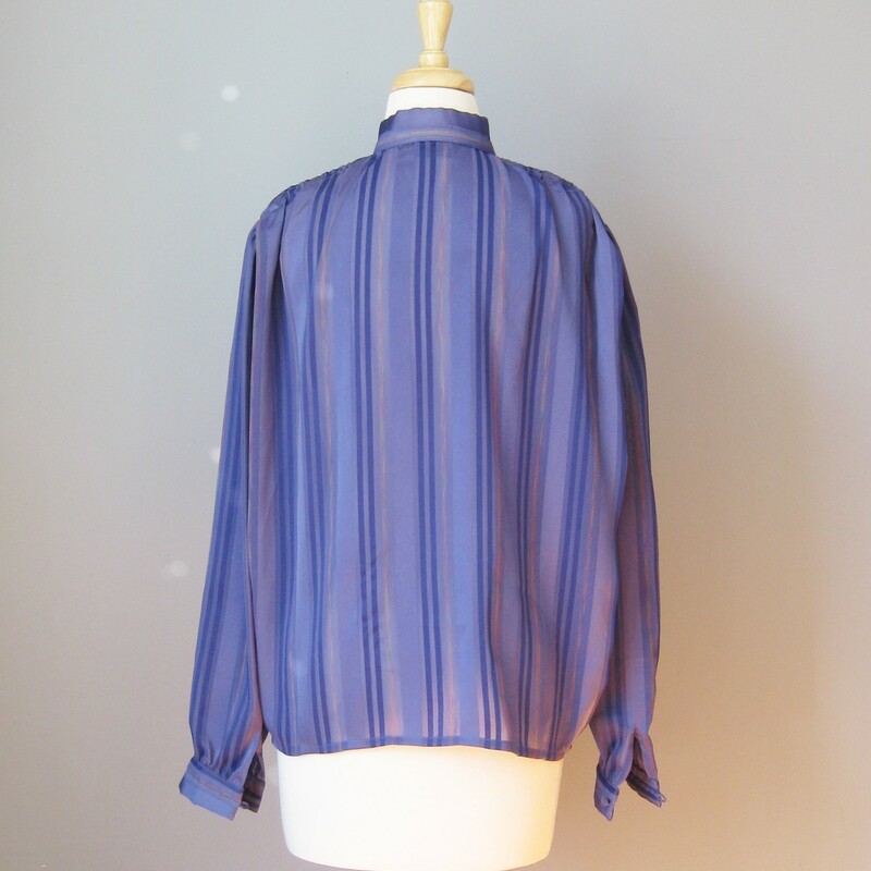 Simple semi sheer blouse in purple
Alternating stripes of purple , pink and sheer sections
High button collar
by Janine

Shoulder to shoulder: 17in
Armpit to Armpit: 24in
Waist: 24in
Length: 26in
Underarm sleeve seam length: 17in

Thanks for looking!

#14536