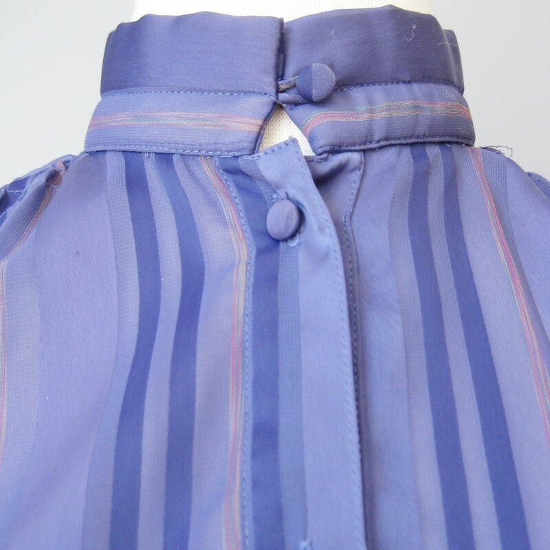 Simple semi sheer blouse in purple<br />
Alternating stripes of purple , pink and sheer sections<br />
High button collar<br />
by Janine<br />
<br />
Shoulder to shoulder: 17in<br />
Armpit to Armpit: 24in<br />
Waist: 24in<br />
Length: 26in<br />
Underarm sleeve seam length: 17in<br />
<br />
Thanks for looking!<br />
<br />
#14536