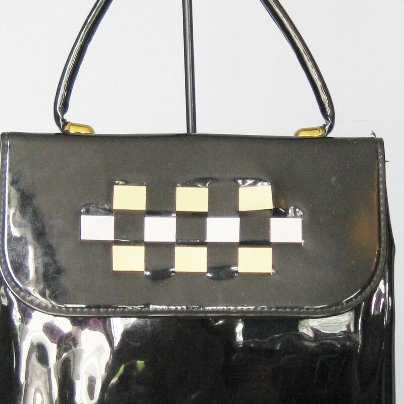 super cute vintage bag in black patent leather
Top Handle, slim style
Three metal foil strips are woven into the flap for decoration.  Two 'gold' ones and a 'silver' one in the middle
No tags
Faille Lining
Snap closure

The bag is in great shape with some imperfections on the patent leather. No gashes but some dull areas

Width: 8.5in
Height: 9 1/2in
Depth: 2;5in
Handle drop: 4in

Thanks for looking!
#13999