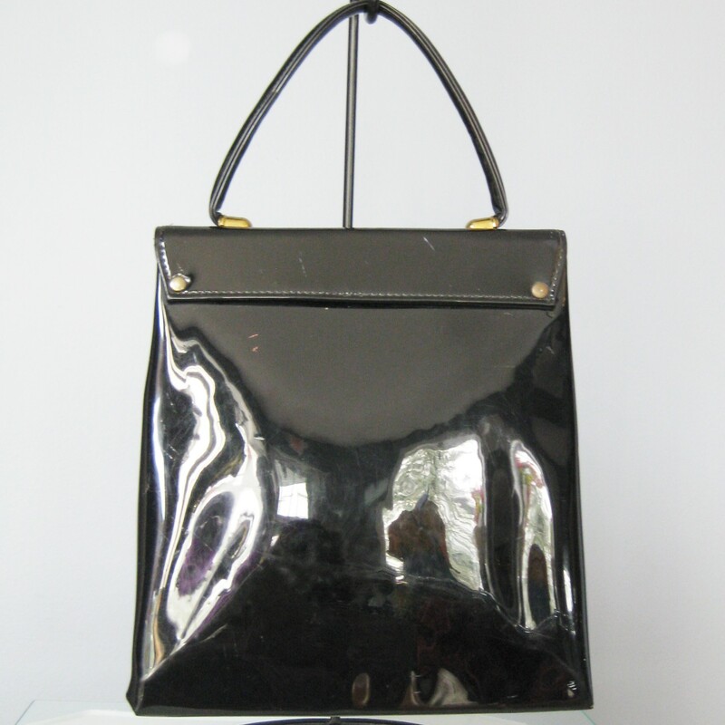 super cute vintage bag in black patent leather<br />
Top Handle, slim style<br />
Three metal foil strips are woven into the flap for decoration.  Two 'gold' ones and a 'silver' one in the middle<br />
No tags<br />
Faille Lining<br />
Snap closure<br />
<br />
The bag is in great shape with some imperfections on the patent leather. No gashes but some dull areas<br />
<br />
Width: 8.5in<br />
Height: 9 1/2in<br />
Depth: 2;5in<br />
Handle drop: 4in<br />
<br />
Thanks for looking!<br />
#13999