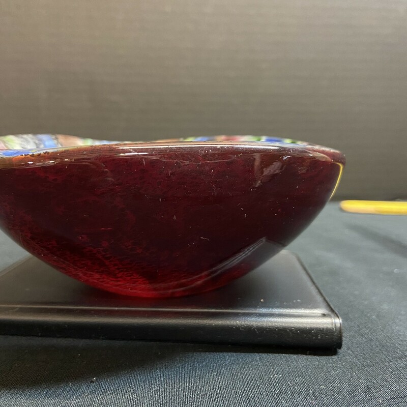 Lustrous multi colored Murano glass bowl with a deep red exterior.