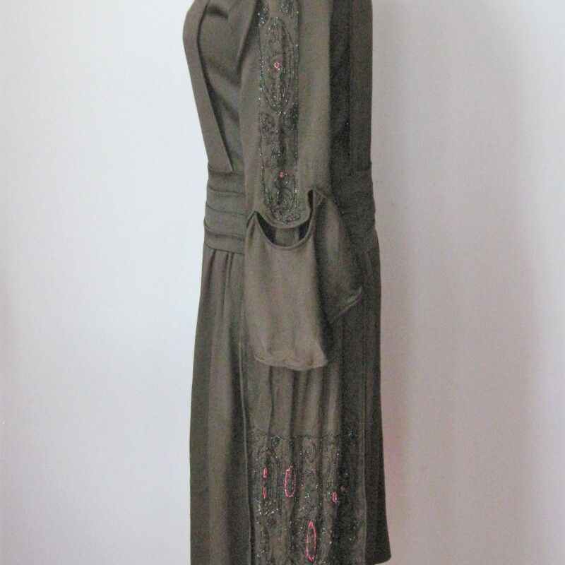 This is an antique dress from the 1920s, possibly earlier.<br />
This dress has a straight dropped waist silhouette and super interesting construction<br />
Two part sleeves, the upper part is beautiufully beaded in small jet beads and some pink rocaille beads.<br />
There is a panel of the same beading hanging from each side of the hip area, these are attached at the hips and free to swing as you move.<br />
The front panel snaps just over the left shoulder and at the cummerbund.<br />
Underneath the front panel is an under shirt that fastens with hooks and eyes.<br />
Unlined<br />
<br />
CONDITION: please read.<br />
Fabric deterioration - especially under the beading on one of the hip panels.  I think this could be stablized with some black lightweight interfacing applied very carefully to the back.  I did not dare to attempt.<br />
Piping on one sleeve has some minor damage<br />
The black has faded on the front panel so it looks a little red<br />
Perspiration stains visible<br />
Pinholes through out the skirt, easily camoflaged with a black slip.<br />
<br />
This delicate dress is for someone who knows what they're doing and can restore it. Or you can buy it to display.  You could wear it as well.  It looks perfectly lovely until you start inspecting carefully.  PLease don't hesitate to contact me with any questions you might have.<br />
<br />
Here are the flat measurements, please double where appropriate:<br />
<br />
Shoulder to shoulder: 15 1/2in<br />
Armpit to armpit: 17in<br />
Waist: 16in<br />
Hip: 22in<br />
Length: 42in<br />
<br />
Thank you for looking.<br />
#10961