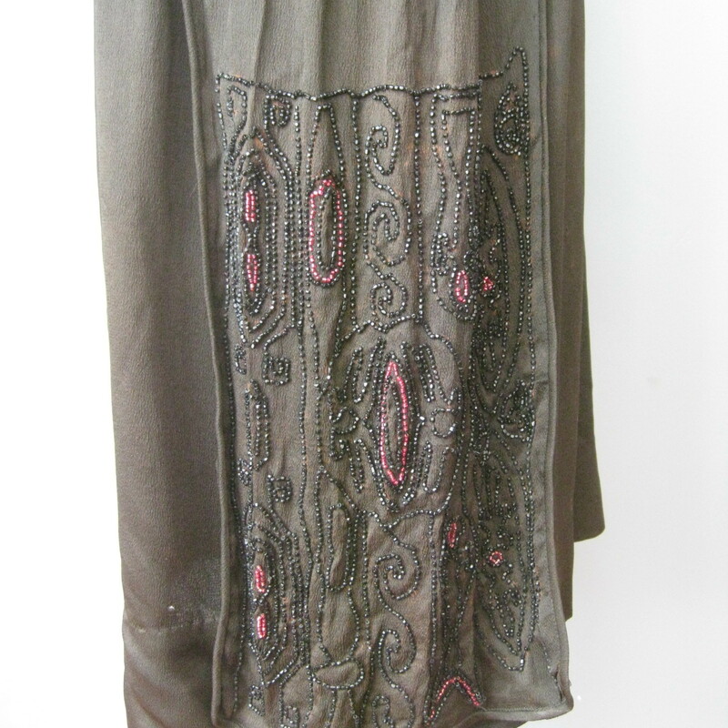 This is an antique dress from the 1920s, possibly earlier.<br />
This dress has a straight dropped waist silhouette and super interesting construction<br />
Two part sleeves, the upper part is beautiufully beaded in small jet beads and some pink rocaille beads.<br />
There is a panel of the same beading hanging from each side of the hip area, these are attached at the hips and free to swing as you move.<br />
The front panel snaps just over the left shoulder and at the cummerbund.<br />
Underneath the front panel is an under shirt that fastens with hooks and eyes.<br />
Unlined<br />
<br />
CONDITION: please read.<br />
Fabric deterioration - especially under the beading on one of the hip panels.  I think this could be stablized with some black lightweight interfacing applied very carefully to the back.  I did not dare to attempt.<br />
Piping on one sleeve has some minor damage<br />
The black has faded on the front panel so it looks a little red<br />
Perspiration stains visible<br />
Pinholes through out the skirt, easily camoflaged with a black slip.<br />
<br />
This delicate dress is for someone who knows what they're doing and can restore it. Or you can buy it to display.  You could wear it as well.  It looks perfectly lovely until you start inspecting carefully.  PLease don't hesitate to contact me with any questions you might have.<br />
<br />
Here are the flat measurements, please double where appropriate:<br />
<br />
Shoulder to shoulder: 15 1/2in<br />
Armpit to armpit: 17in<br />
Waist: 16in<br />
Hip: 22in<br />
Length: 42in<br />
<br />
Thank you for looking.<br />
#10961