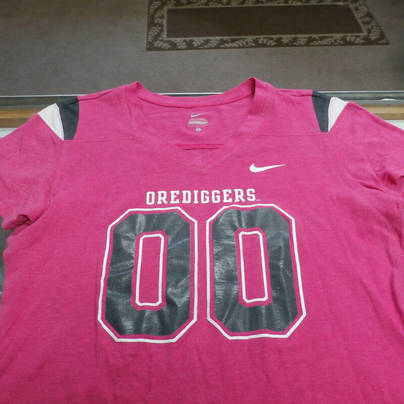 Montana Tech Orediggers Nike Women's V Neck Cap Sleeve Large Pink #25353
Rating: (see below) 3 - Good Condition
Team: Montana Tech Orediggers
Player: N/A
Brand: Nike
Size: Women's - Large(Measured: Across chest 18\", length 24\")
Measured: Armpit to armpit; shoulder to hem
Color: Pink
Style: Cap sleeve V Neck; screen pressed logo
Material: 60% Cotton 40% Polyester
Condition: 3 - Good Condition - wrinkled; pilling and fuzz; feels coarse; material is stretched and worn; normal signs of wear; no stains rips or holes
Item #:  25353
Shipping: FREE