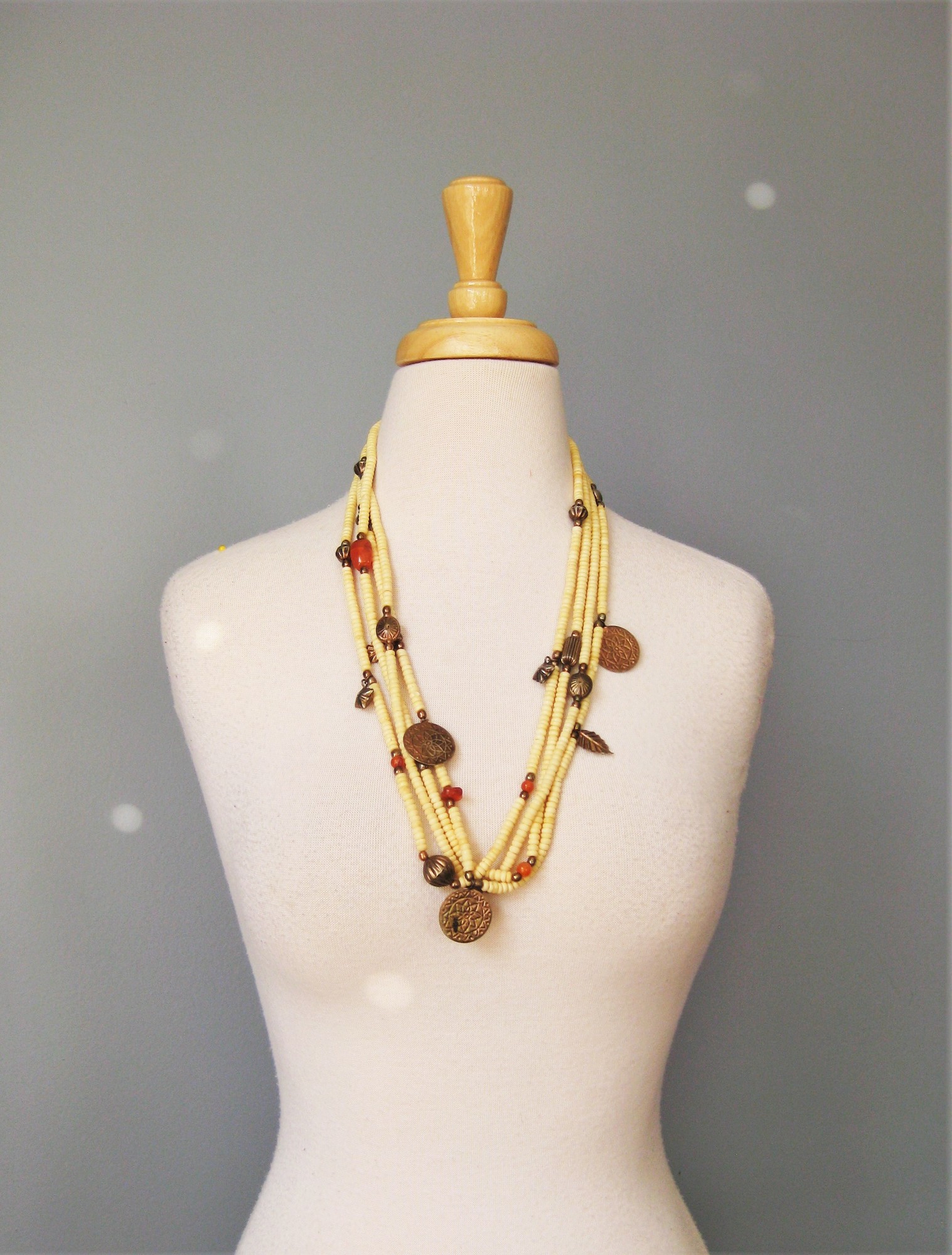 Wood And Brass, Ivory, Size: None
Tribal style necklace made from multiple strands of ivory and orange beads, metal coins and charms

Wear as shown or twist it into a choker length torsade.\\


28.75in long
closes with a silver toned hook

thanks for looking!
#40106
