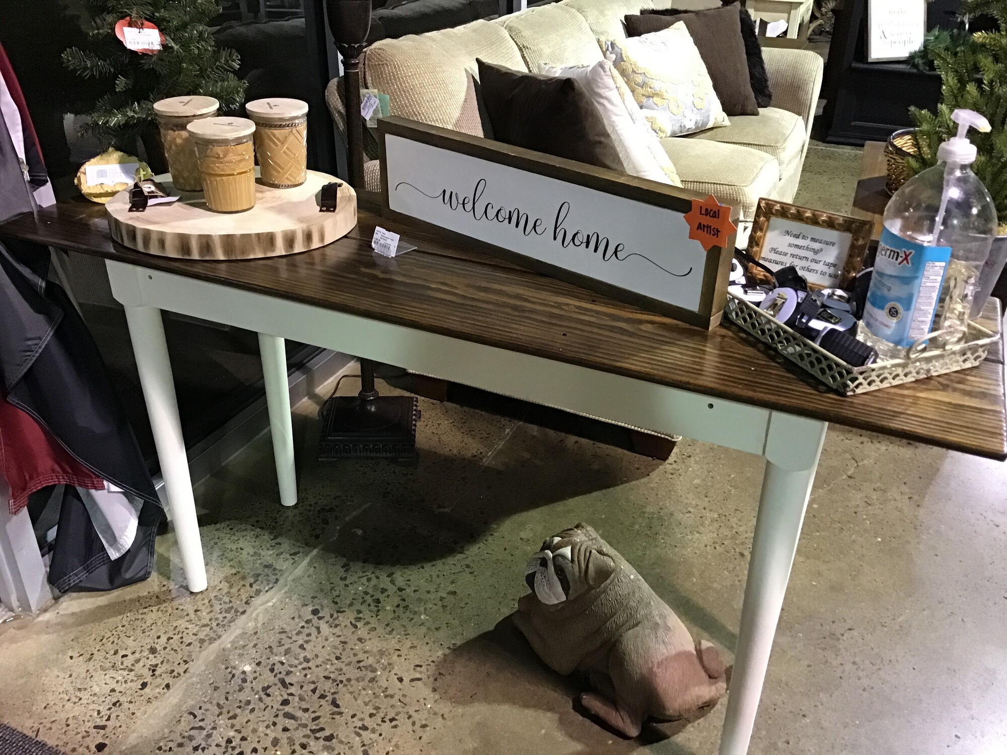 This gorgeous console table was handmade by one of our local artists.The top and sides are made from reclaimed bleacher seats from Grove City School District.  The legs are from a display table that he bought from a local Macy's when they went out of business. Such rich heritage with this piece!
Dimensions are 60 in x 18 in x 30 in