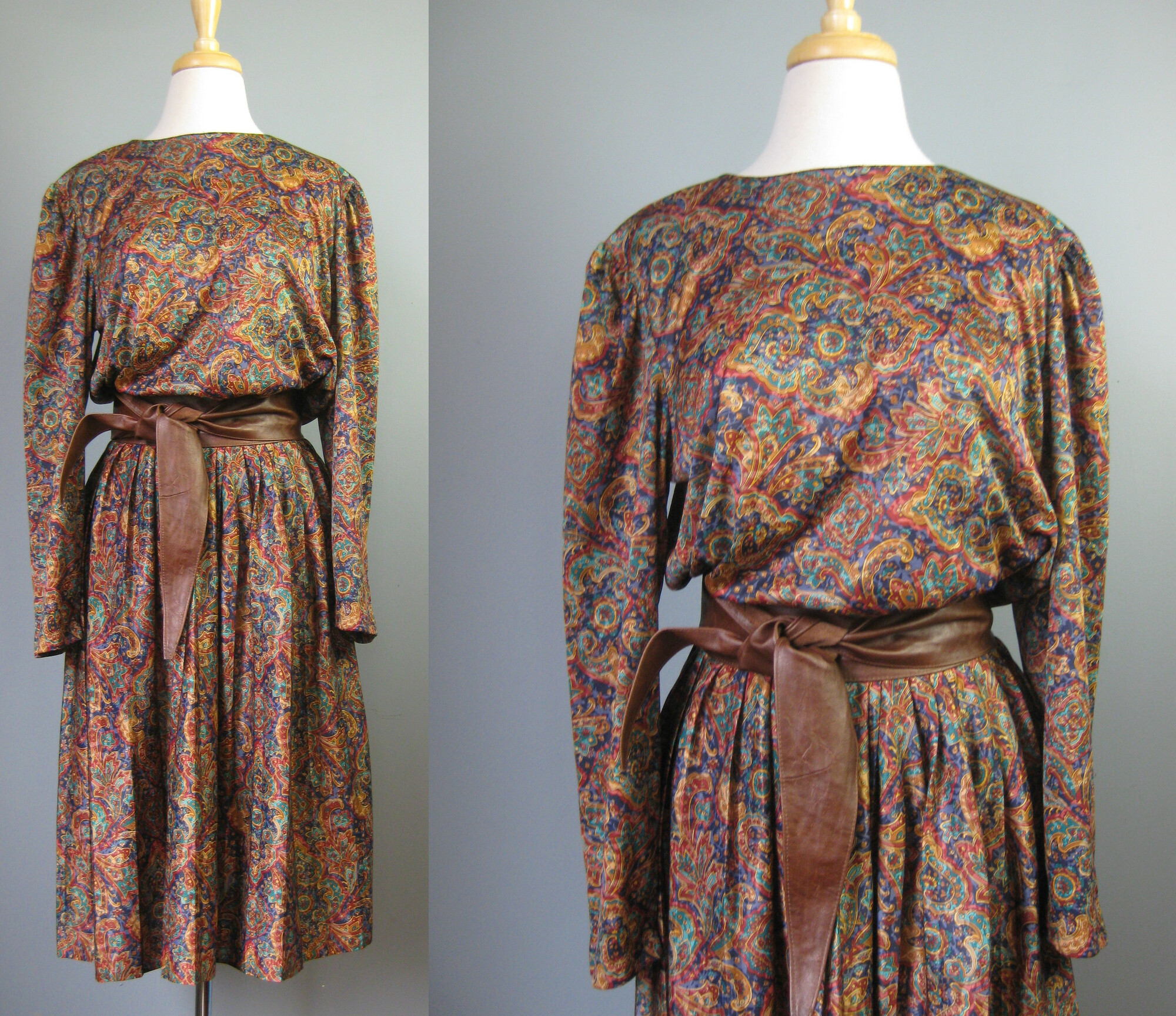Vtg Bedford Fair Secretar, Jewel, Size: Large
Here is a pretty paisley secretary dress from the 1970s.  It's made of a silky fluid polyester and it is by Bedford Fair.  You pull it on over the head.  It has one button at the back of the neck and an elastic waist.
The colors are teal gold burgundy and purple but it gives off a warm tone brown vibe.  I've paired it with a gorgeous brown leather obi belt that is NOT INCLUDED but available separately.  I think they look great together
Long sleeve
Unlined
Flat measurements:
Shoulder to shoulder: 18
armpit to armpit: 21.25
Waist: 13 to 21
Hip: free
Length: 45
Underarm sleeve seam: 16.5
perfect condition!

Thanks for looking!
#15936