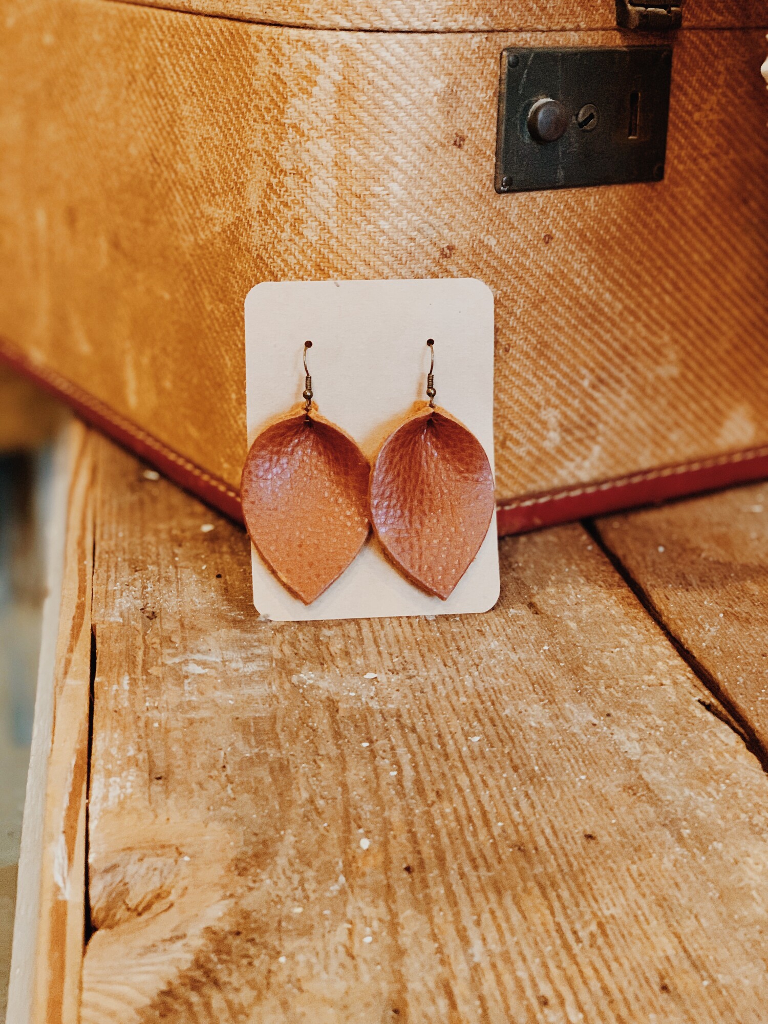 These genuine leather earrings from The Olive Branch were carefully designed and hand crafted. They measure 3 inches long.