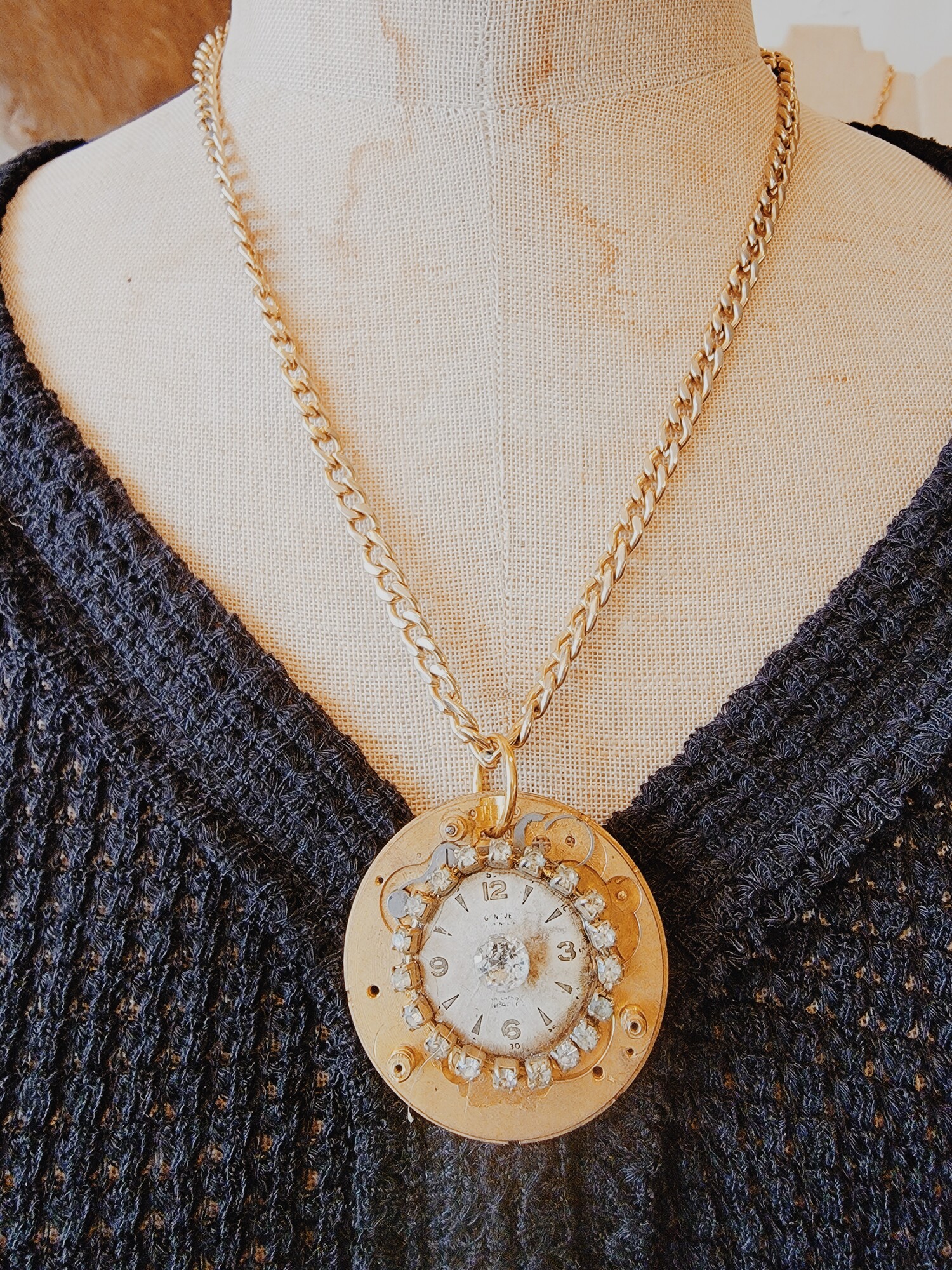 This hand crafted necklace has a vintage watch face on its pendant circled in rhinestones!
Chain: 21 Inches