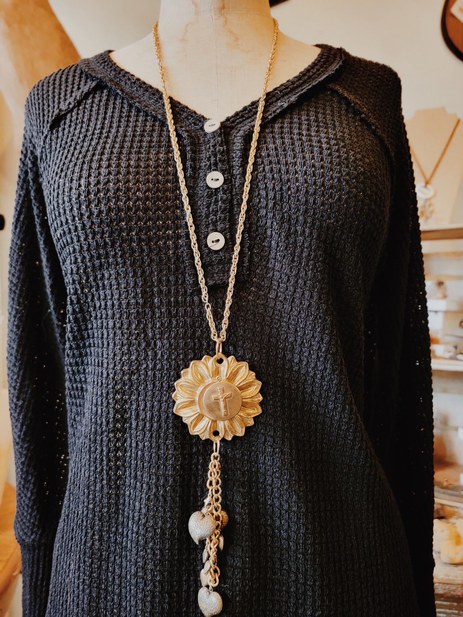 This unique necklace is definitely one you will want to snag before it is gone! The artist that hand crafted it used a vintage floral medallion as the pendant and attached a locket to the front that opens and reads The Lord's Prayer inside.
Chain: 34 Inches