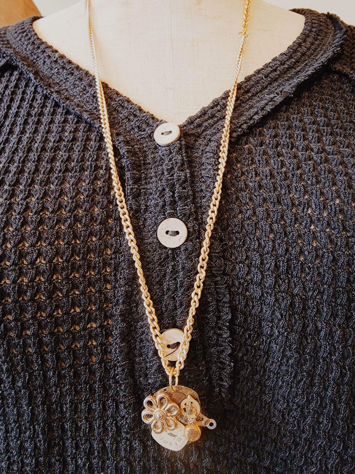 This adorable necklace was hand crafted! The pendant is a collage of different watch faces and parts!
Chain: 30 Inches