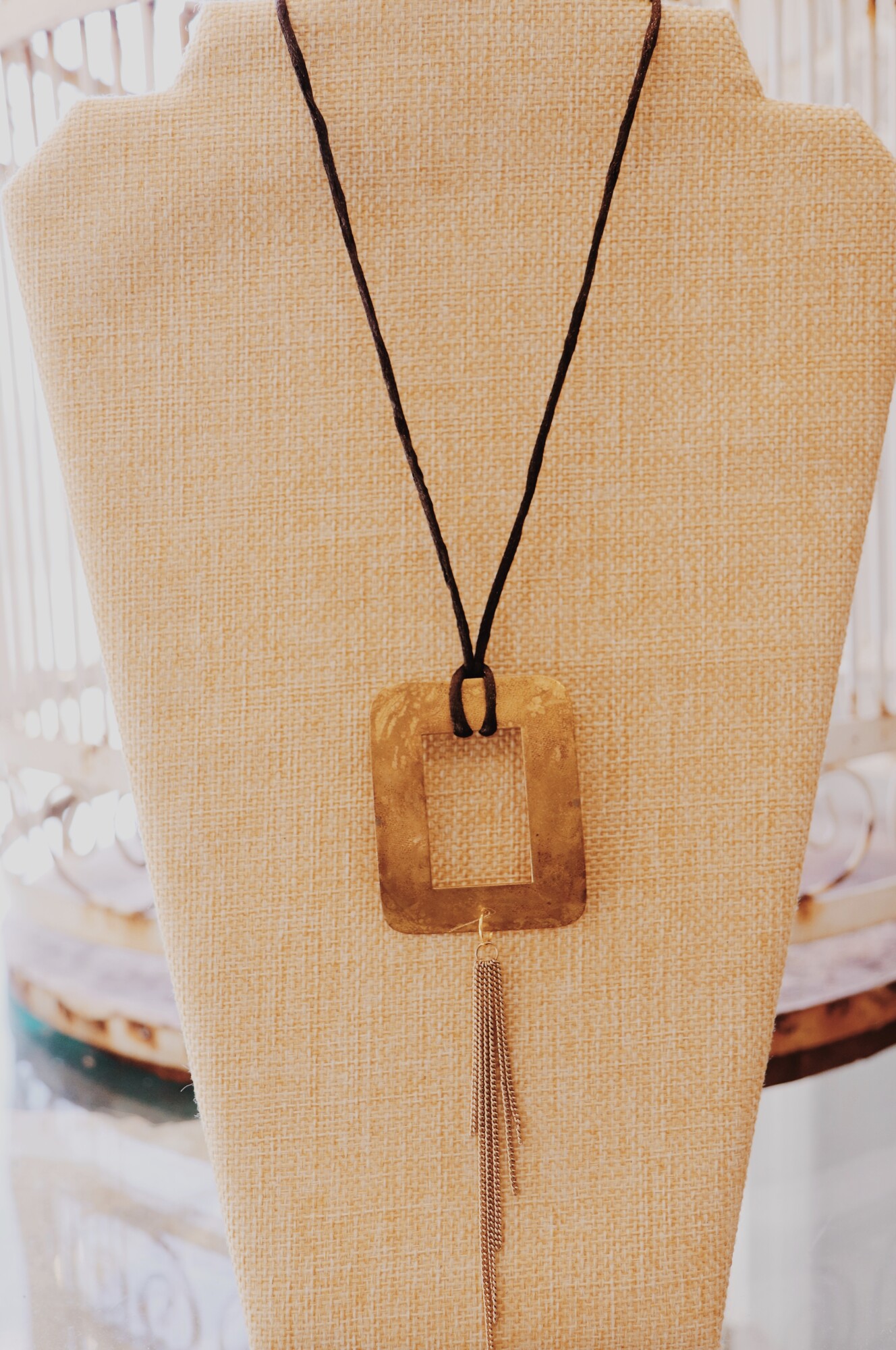 This necklace from Kelli Hawk Designs was handmade from vintage pieces! The beautiful brass pendant and fringe chain measures 5.5 inches long, and the necklace is on a 15 inch cord with a 2 inch extender.