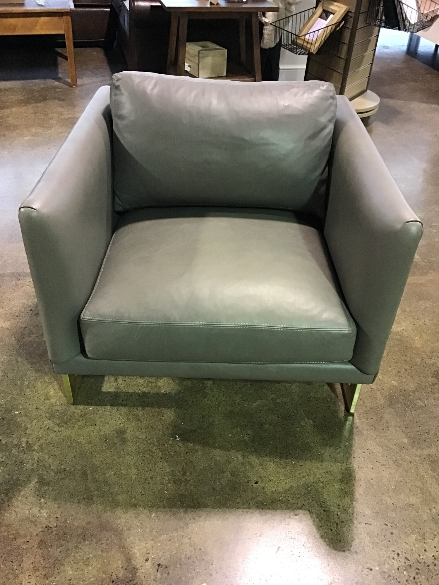 This super chic gray leather chair from RH is still featured on their website today! The chair is from the Milo Baughman collection and is model #3426 (current retail for RH Members is $5400!). Crafted by American designer Milo Baughman in 1968, this visually arresting chair features an upholstered cube that seems to float inside an angular flat-bar frame. Thick, loose cushions offer ultra-comfortable seating. Made by hand today as it was more than four decades ago by Thayer Coggin, master furniture crafters in North Carolina.
Dimensions are 31 in x 31 in x 29 in