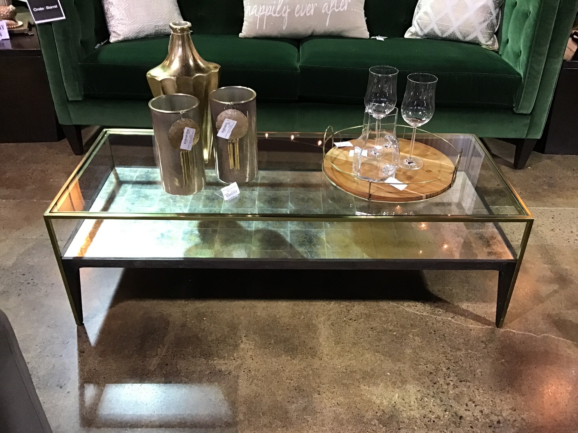 This coffee table is super on-trend! It features a brass (gold) frame and silver/gold detailing on the shelf under the glass. There is even some dark brown detailing to bring warmth to the piece! Love this table in front of our emerald green sofa!
Dimensions are 51-1/2 in x 21-1/2 in x 16 in
