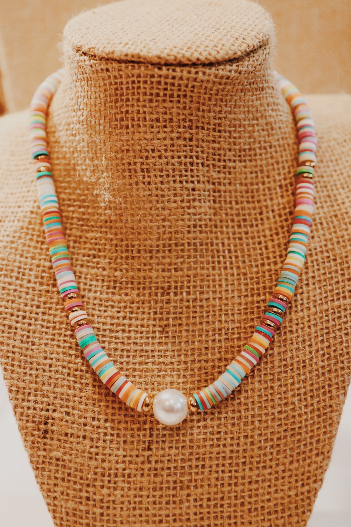 This fun necklace with a pearl center is on a 16 inch strand with a 2 inch extender!