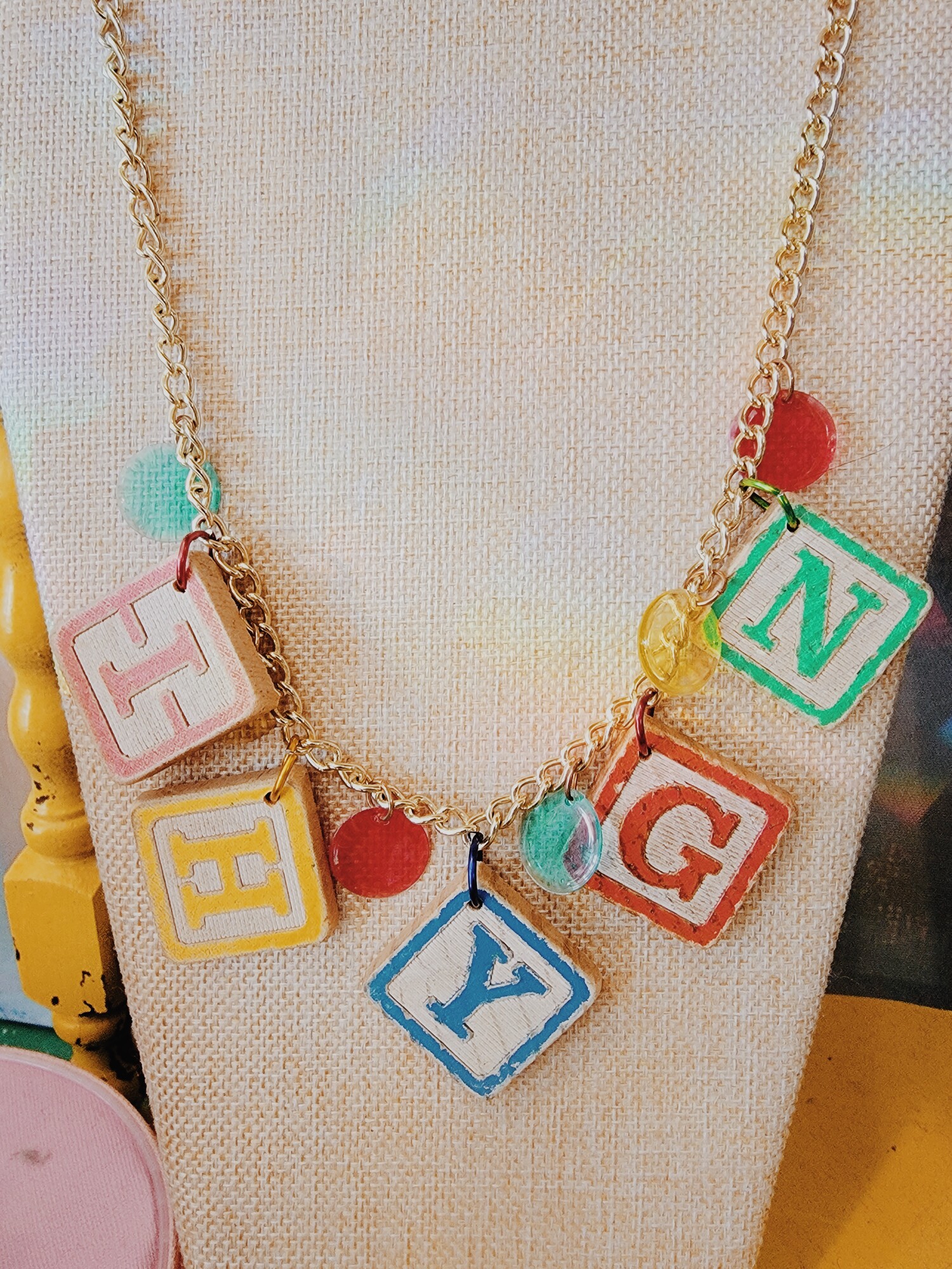 This Kelli Hawk Designs necklace is truly one of a kind! With game pieces as the centerpiece, this necklace is perfect for those who love to be unique! It hangs on a 21 inch chain.