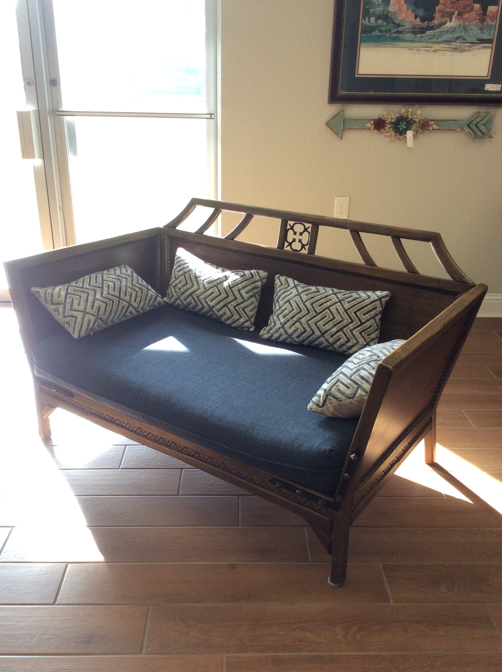 This beautiful vintage settee features a dark wood finish,  lovely carved details and is upholstered in navy blue. 4 accessory pillows included.