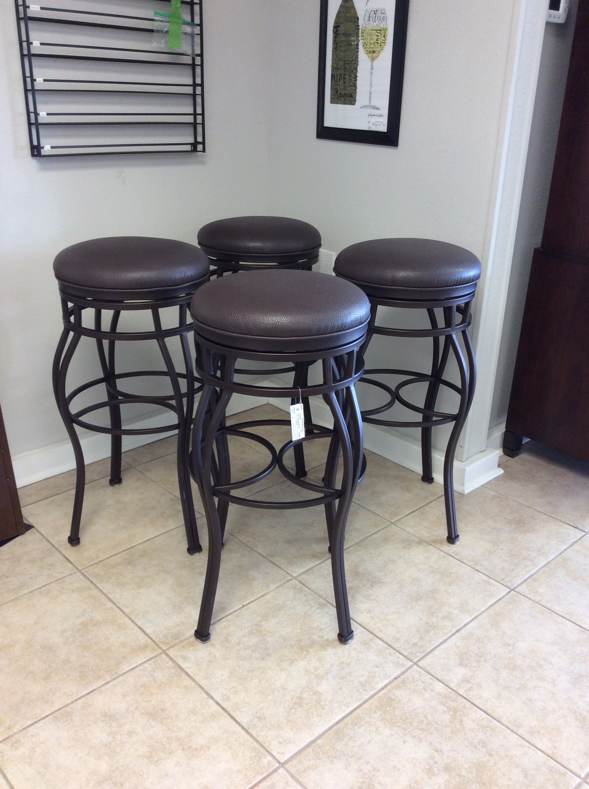 This is a very nice set of 4 swiveling barstools. Contemporary in style, they are a lovely combination of metal and leather.