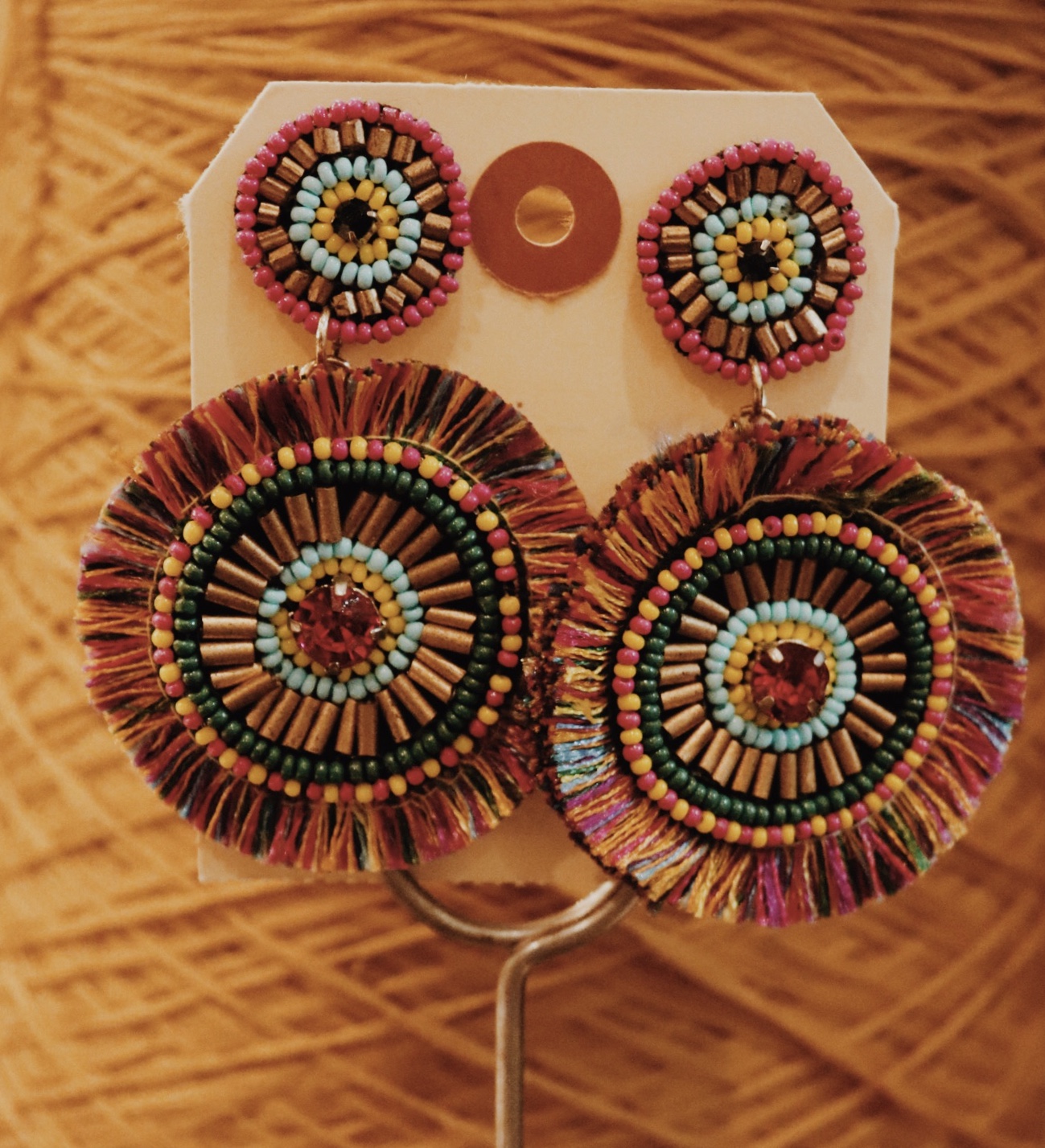 These fun earrings measure 3 inches long. They are so fun and colorful to add flare to any fit!