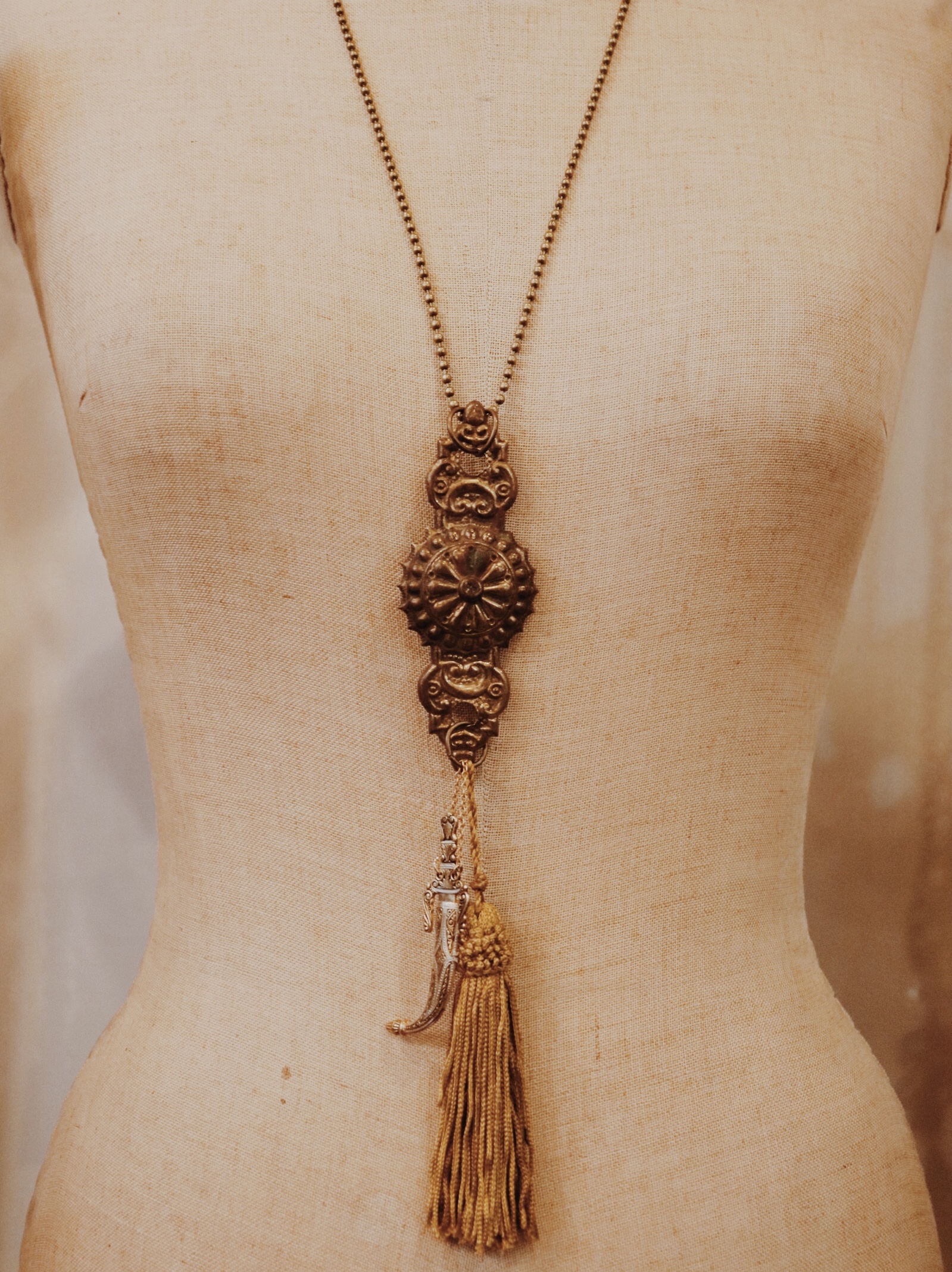 This beautiful brass necklace is handmade and hangs on a 28 inch chain!