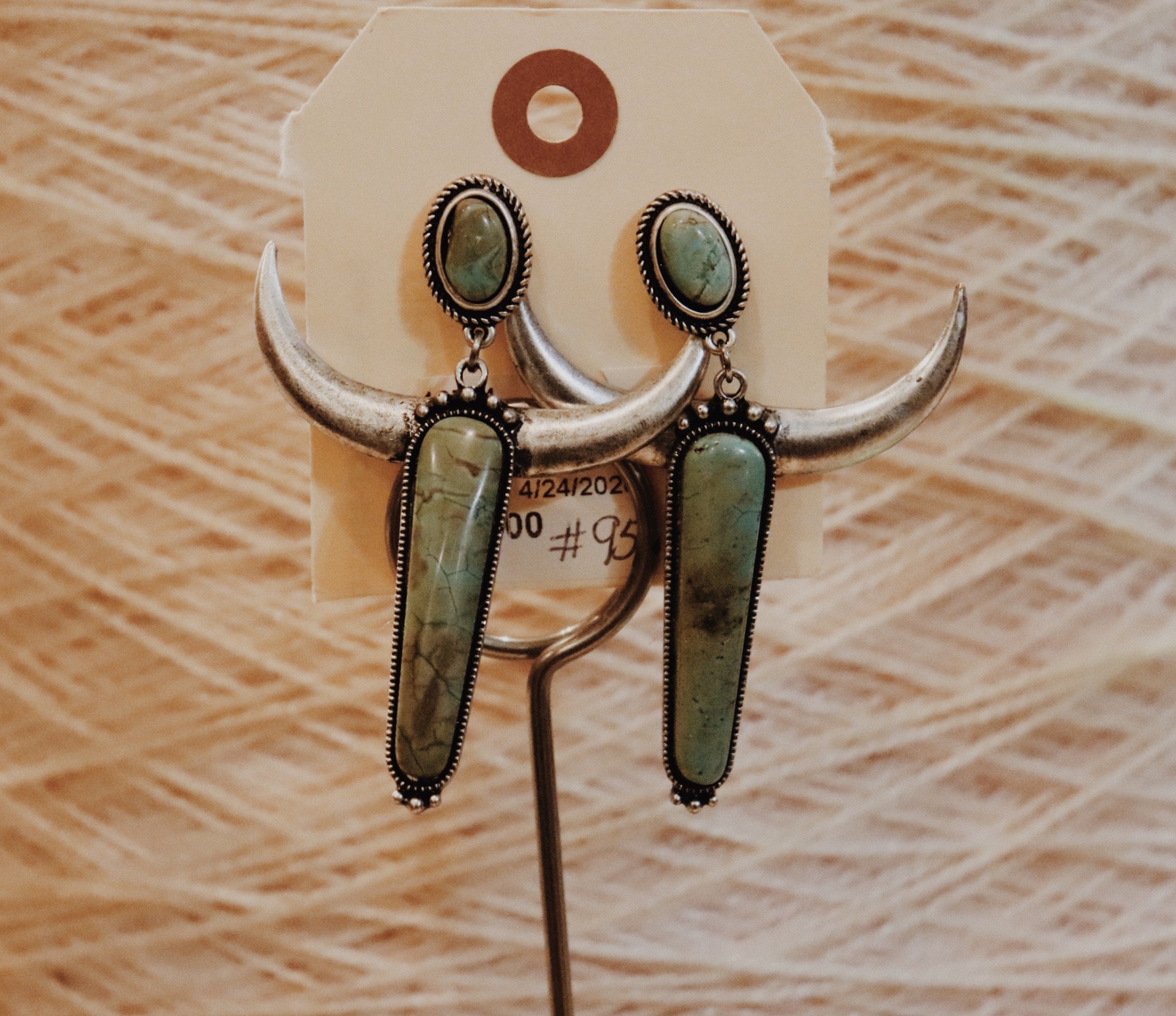 Turquoise Steer Earrings with a silver tone. Medium weight and 3 inches long.