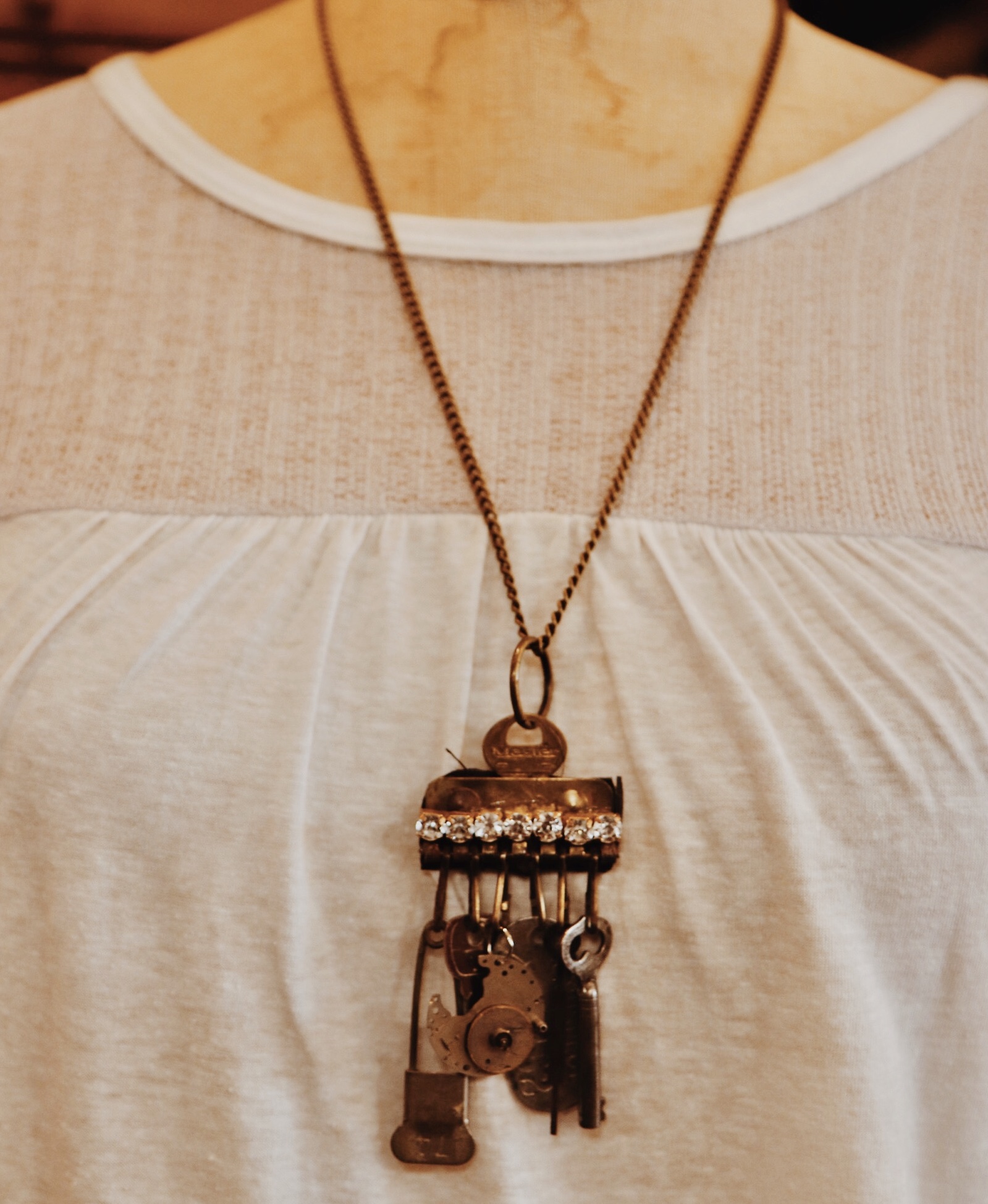 This handmade necklace has an assortment of vintage trinket as the pendant and hangs on a 26 inch chain!