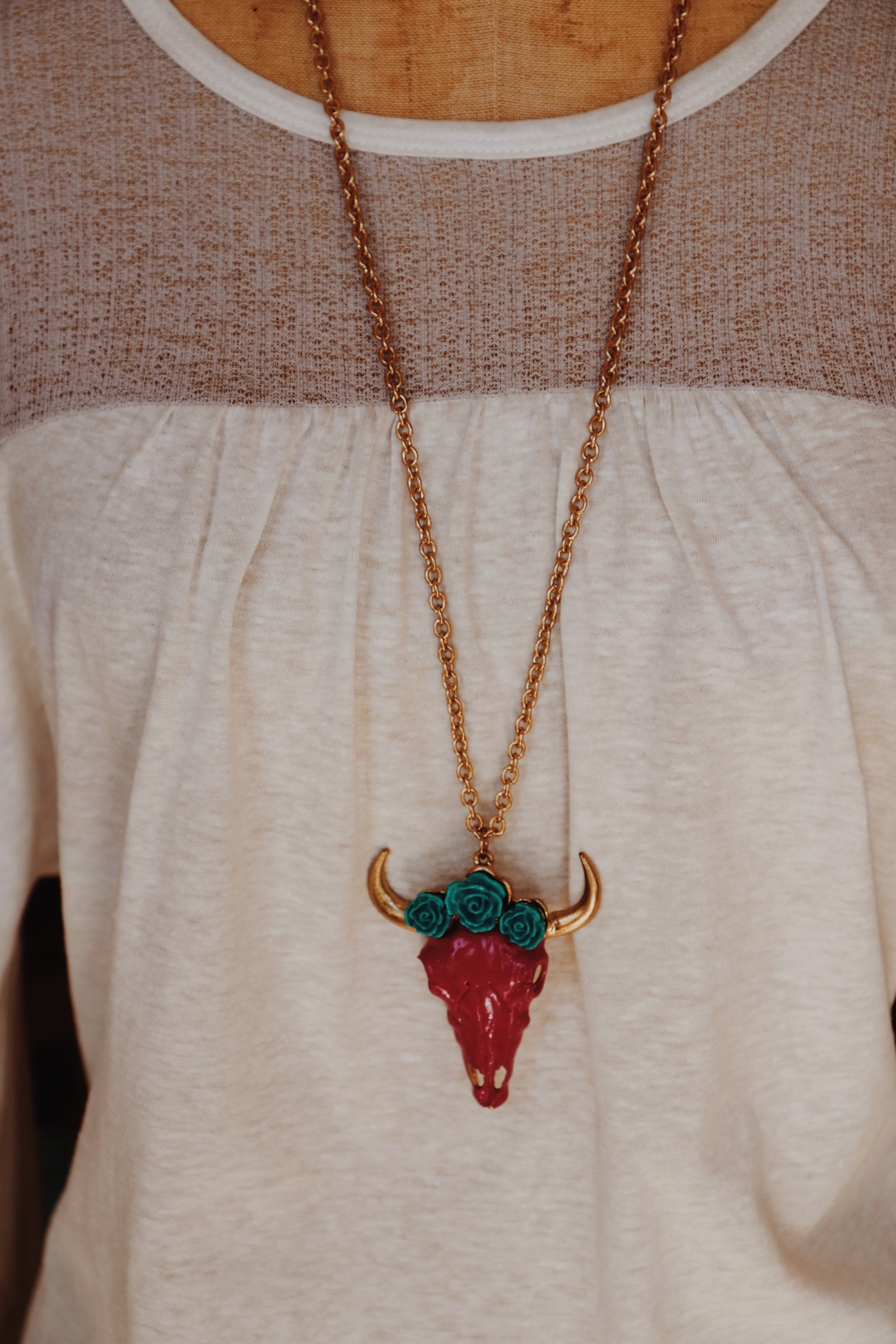 Boho Magenta Pink Cow Skull with turquoise flowers Gold Necklace. This is super cute paired with the magenta pink Beaded necklace. Sold seperately.
