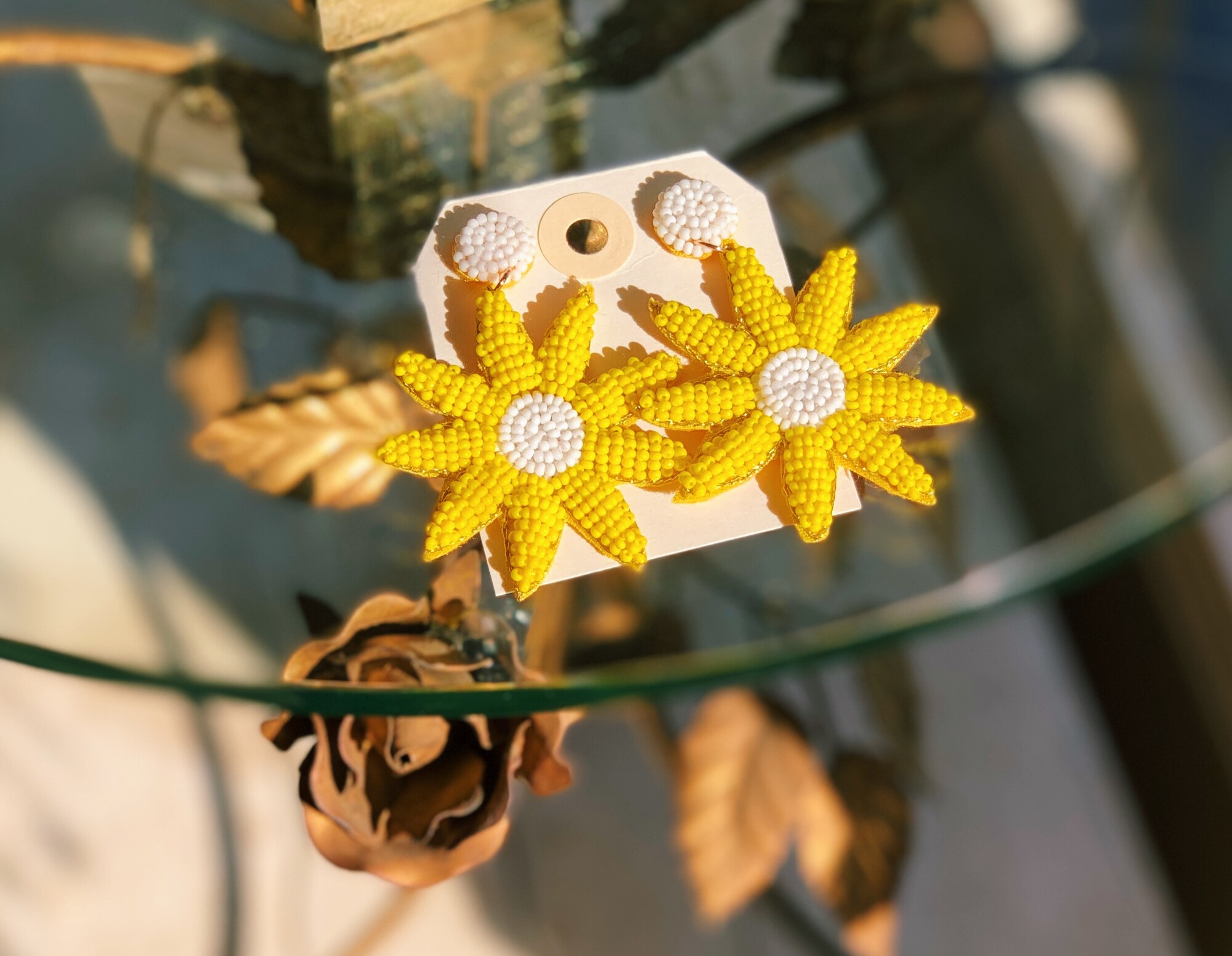 These adorable, bright yellow flower earrings measure about 2.5 inches long!