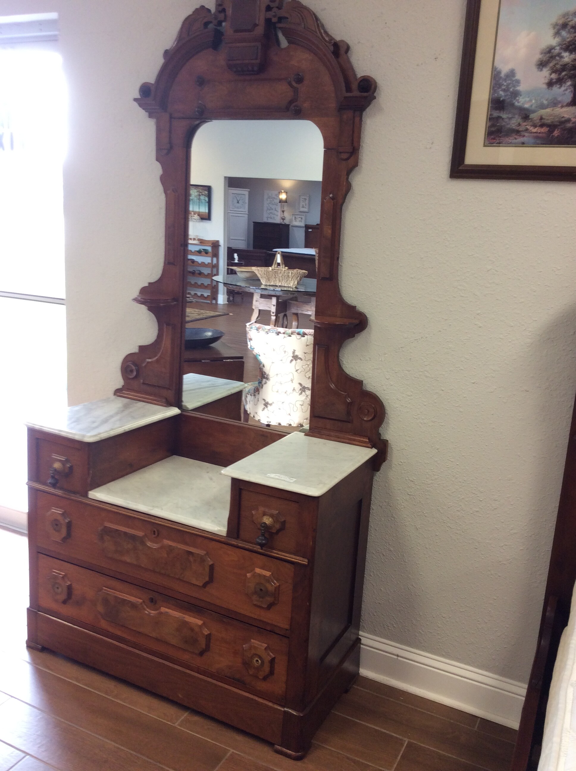 This is a  lovely Victorian mahogony dresser and mirror. The mirror has a pair of carved shelves. The dresser top is marble and has the original hardware.