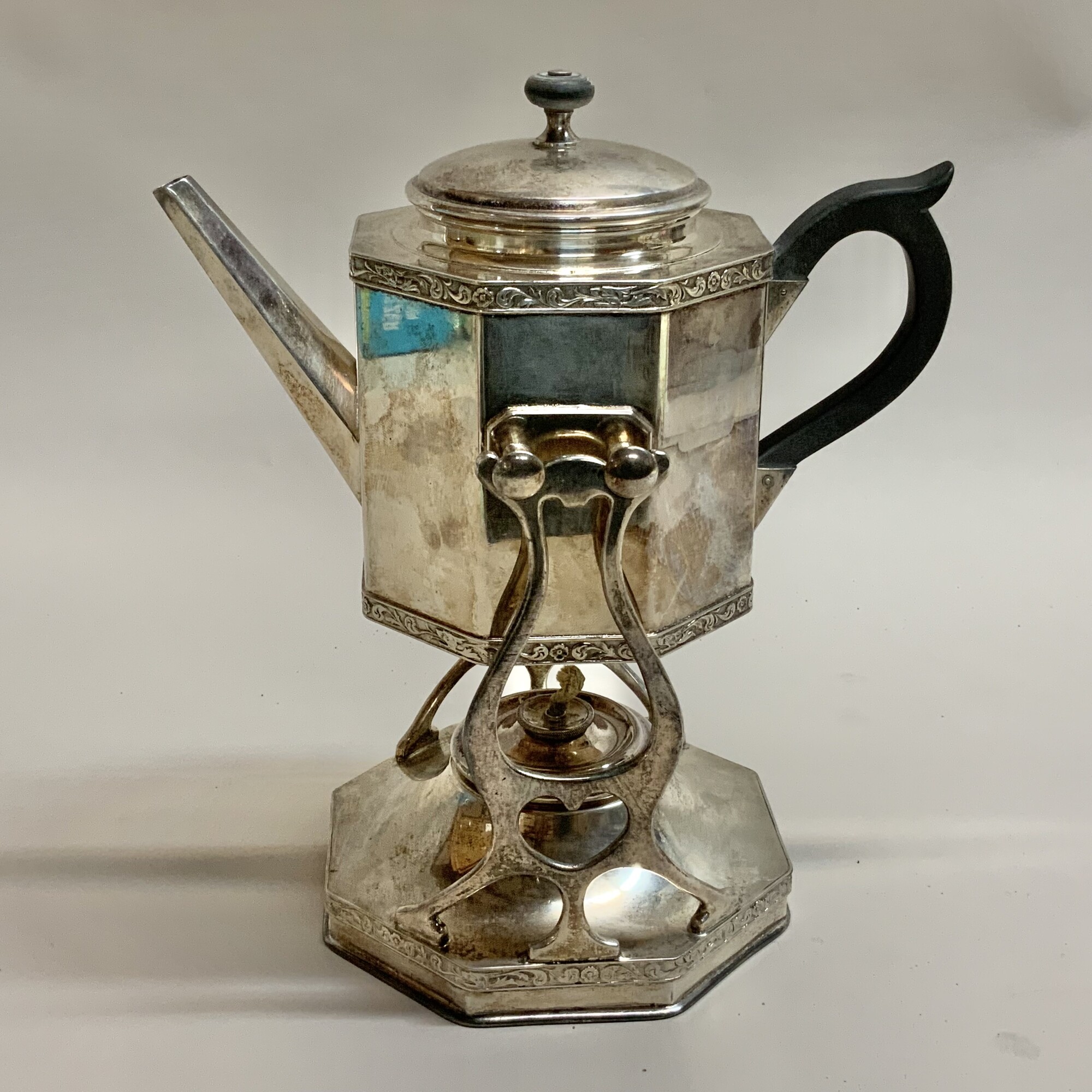 Vintage silver plated hot water kettle with stand and burner Used to keep water hot for the preparation of tea at the table
Marked on the bottom of kettle see photo
In fair condition has been vigorously polished over its lifetime and the silver plate is quite thin Black color handle and finial on lid have faded No dents or deep scratches still a very decorative piece
Kettle and stand are 10.5 inches high