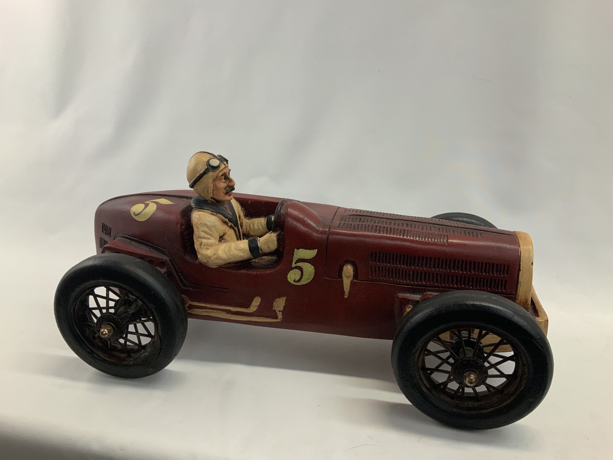 A beautiful very collectible and unique vintage classic large model sculpture race car 1920s Bugatti Type 54 Spider
Made out o f resin or plater with metal spoked rubber wheels complete with driver
20 inches long 10 inches high 10 inches wide Very good condition
A similar model was featured on the TV Show Friends