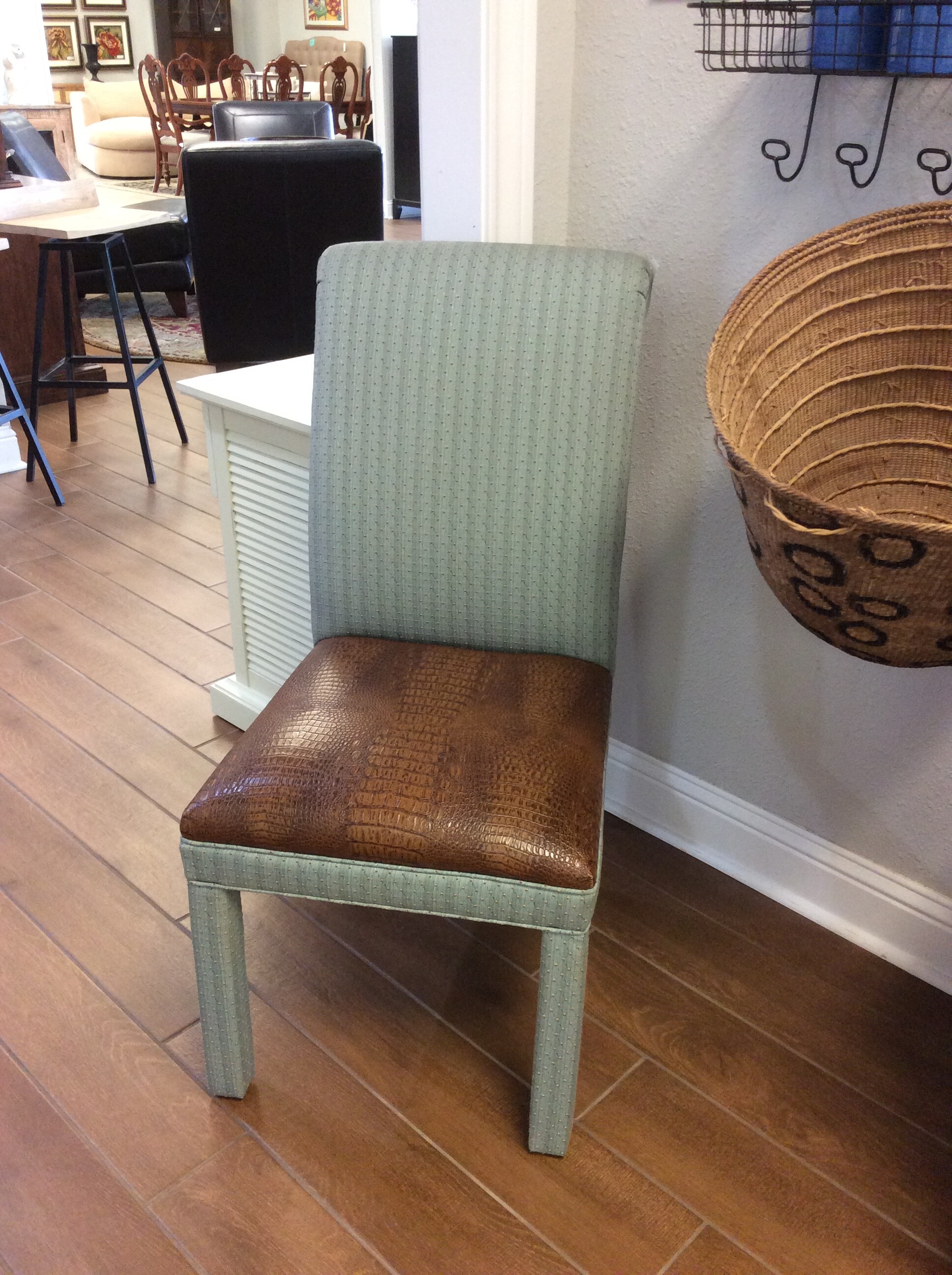 This side chair is a lovely combination of teal and brown. The frame has been upholstered in a soft teal, the chairseat and back in brown leather.