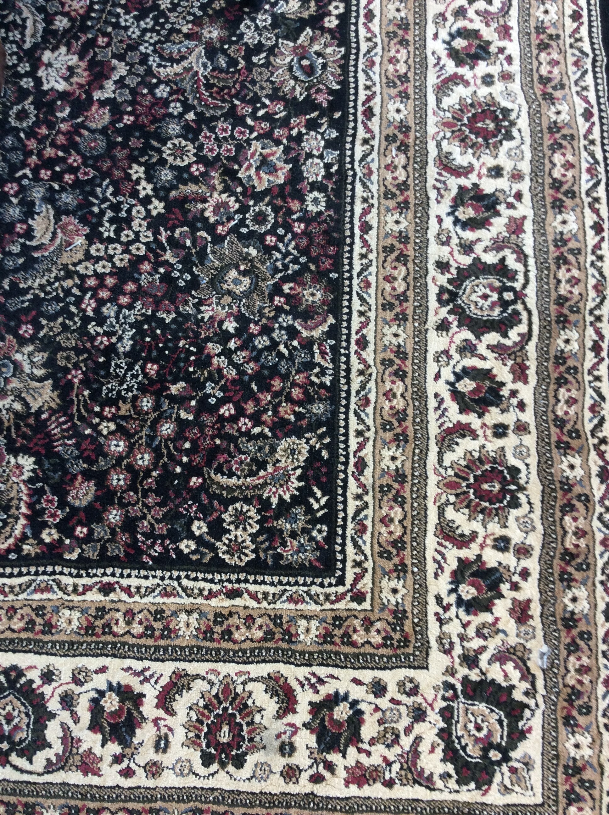 Oriental Weavers Area Rug. This rug is black and cream colored with a beautiful colorful pattern.