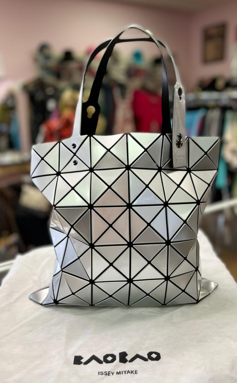 BAOBAO - ISSEY MIYAKE
Lucent Geo Lightweight Collapsible Tote Bag
Bao Bao Issey Miyake \"Lucent\" faux-leather (PVC) tote bag.
Lightweight, collapsible style for easy travel.
Adjustable tote handles.
mesh lining.
Interior zip pocket.
13.4\"H x 13.4\"W.
Made in Japan.
you can shop on line and view the price of this bag, currently still available at
https://us-store.isseymiyake.com/
Care: Wipe gently with a damp, tightly wrung soft cloth, and then wipe dry.
comes with the original duster cover.
In excellent condition.
Original Retail Price:  $590.00
ABOUT THE BRAND
Known for a technology-driven ethos, Japanese designer Issey Miyake has been at the forefront of innovative, architectural design since 1971. His experimentation with pleating resulted in beautiful, wrinkle-proof ready-to-wear—and a new line—Pleats Please Issey Miyake. The multi-talented designer also expanded into fragrance and an accessory line of geometric statement bags under the name Bao Bao Issey Miyake.