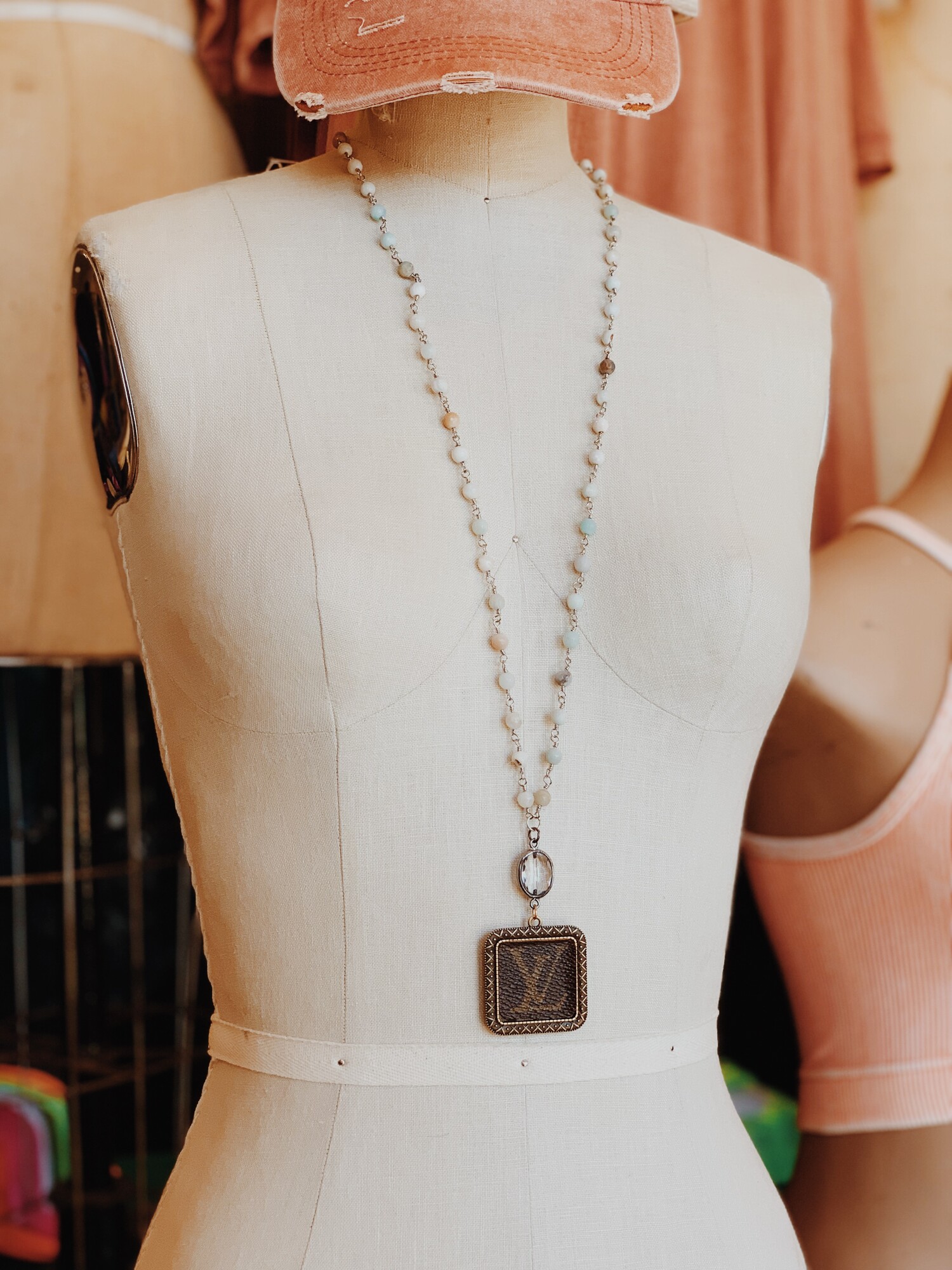 This gorgeous upcycled, handmade necklace was made from an authentic Louis Vuitton bag!

The chain measures 32 inches in length.

Resurrect Antiques is not affiliated with the LV company.
The bag's date code is SP0927