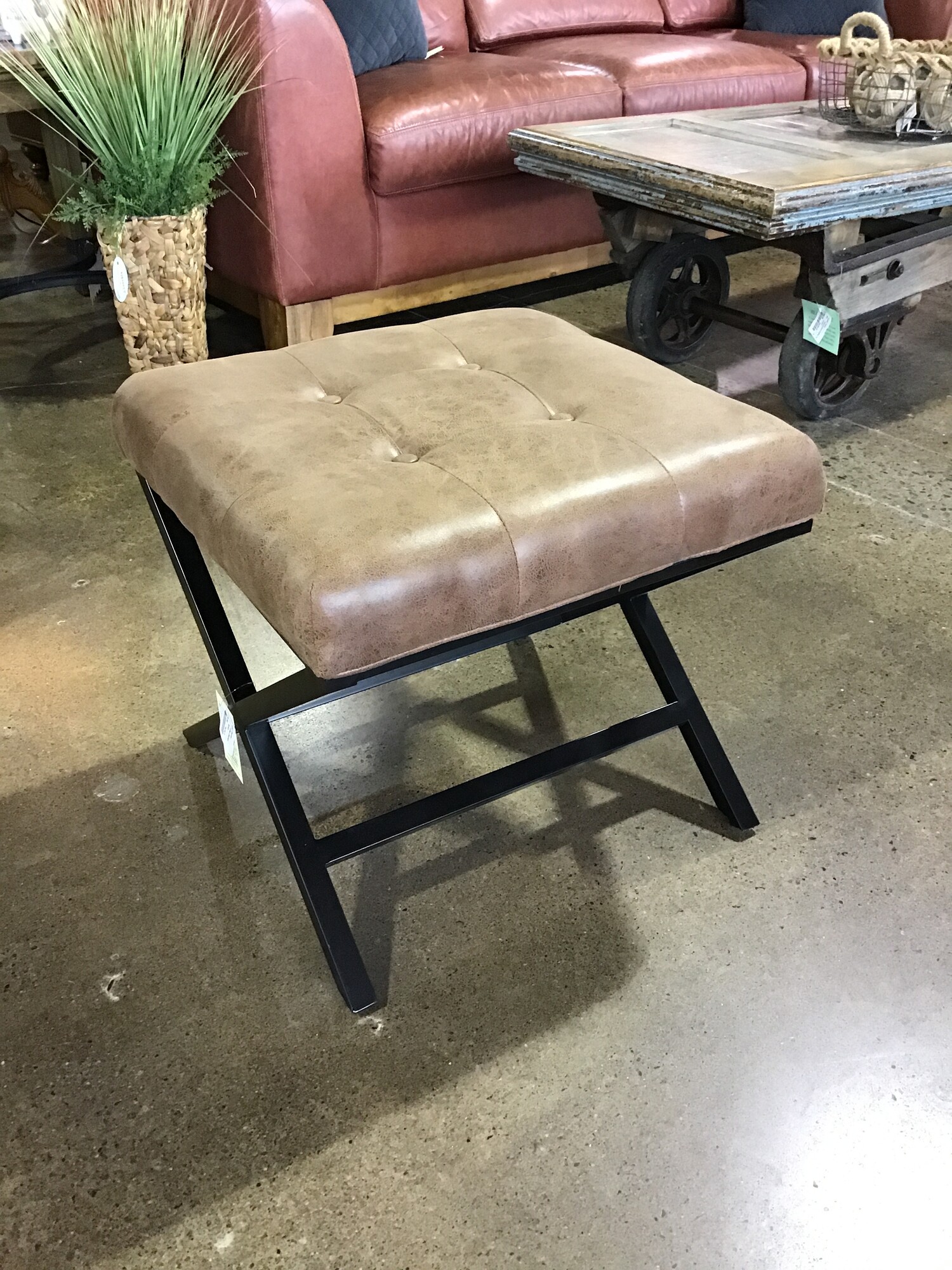 Brown faux leather upholstery and metal base ensure durability.  Tufted detailing creates a visual appeal
Ottoman can serve as a footrest, makeup stool, or an accent piece!  Buy them both and push together as a coffee table!

Matches #144946

Dimensions:  19x19x18