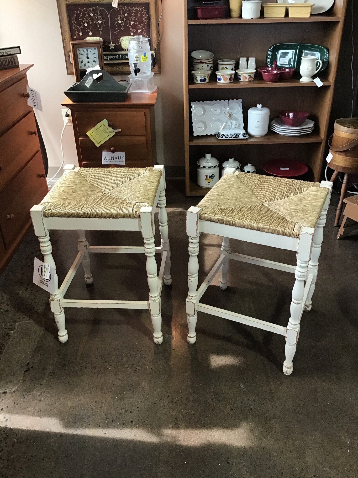 Style, a touch of texture, extra seating!  This pair of Ballard counter stools does it all. They bring fresh style and casual comfort to breakfast nooks, eat-in kitchens and grand dining rooms. Rush seats over a distressed cream frame for an artisan style piece.

Dimensions:  25 inches high