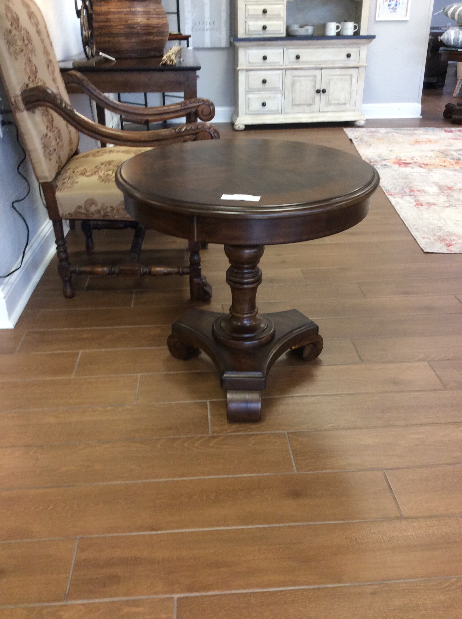 This is a beautiful Dark Rustic Finish Round side table. This Table has circle detail trim with 3 swirled feet.