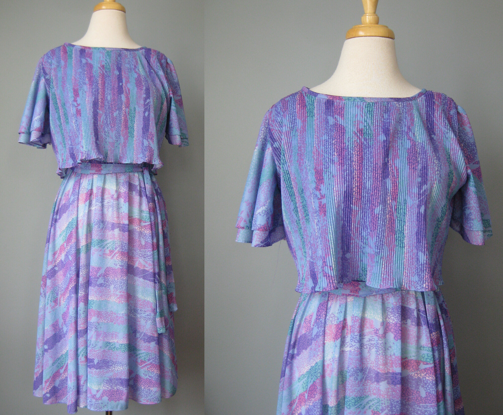 Vtg 70s Floral, Lilac, Size: Small
Sweet below the knee dress in a very lightweight polyester.
Abstract print in purples and blues.
The dress has an elastic waist and a micro pleated capelet.
Flutter sleeves and matching sash
The skirt is sheer so you will need a half slip with it.
No labels but I believe this is from the late 70s, on the cusp of disco fever and it reminds me of the dresses worn by the heroine of Saturday Night Fever.

Here are the flat measurements, please double where appropriate:
Shoulder to shoulder: 15.5
Armpit to Armpit: 20
Waist:  13 stretches comfortably to 16
Hip: free
length: 39

Thanks for looking!
#41301