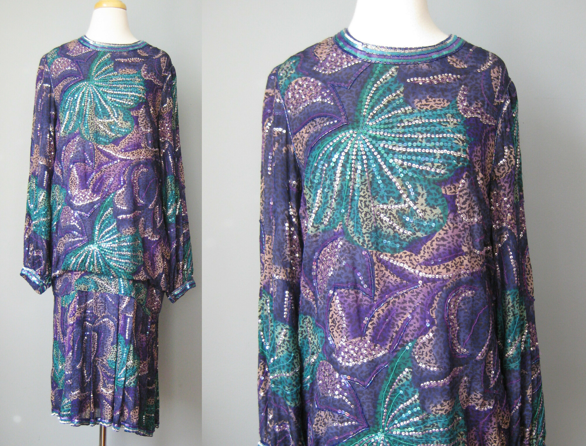 This spectacular sequined silk cocktail dress from the 1980s is perfect for festive evening occasions or a 1920s themed formal party.   The dress is silk and in peacock colors of blue green and purple.  Beaded and embroidered with an abstract fireworks designs.

The dress has a dropped blouson waist and a short pleated skirt
Long sleeves and center back zipper.

100% silk by Judith Ann creations. Made in India

the bad news is that the lining at one shoulder is damaged and weak overall.  It could use a new lining.
It can be worn as is if you are super careful putting it on and taking it off.  I've priced it accordingly!

Marked size M but better for a small.
Here are the flat measurements, please double where appropriate:
Shoulder to shoulder: 15.5
Armpit to Armpit: 19.25
Waist: 20
Hips: 19
Length from back of neck to hem: 42


Thank you for looking.
#46129