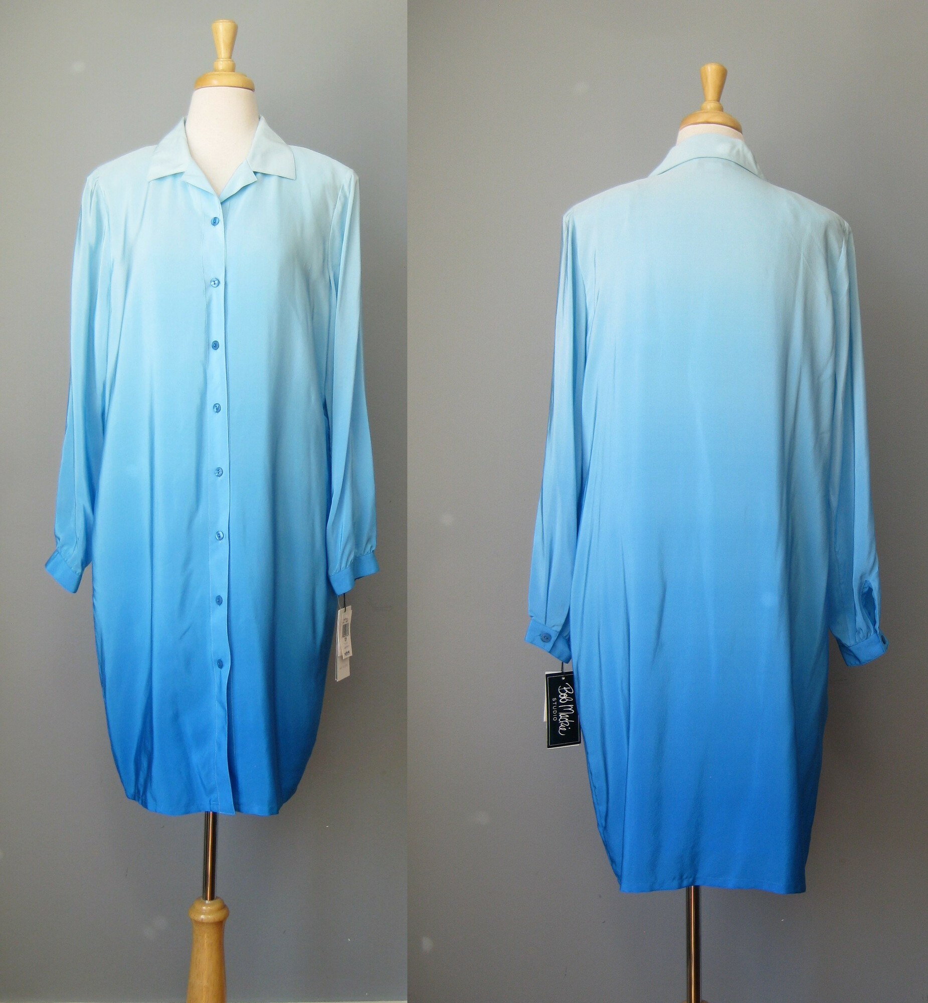 Deadstock piece from Bob Mackie
Heavenly Ombre Blue silk shirt dress or duster
long button sleeves
fully lined
soft shoulder pads set with snaps, removing these will not ruin the line of the garment, as it was designed to be worn either way.

Marked size 12 P
Flat measurements:
Shoulder to shoulder: 16
Armpit to Armpit: 22
Waist: 20.5
Hip: 22.5
underarm sleeve seam: 17.5
Length: 38

Excellent condition, no flaws!
thanks for looking!
#42883