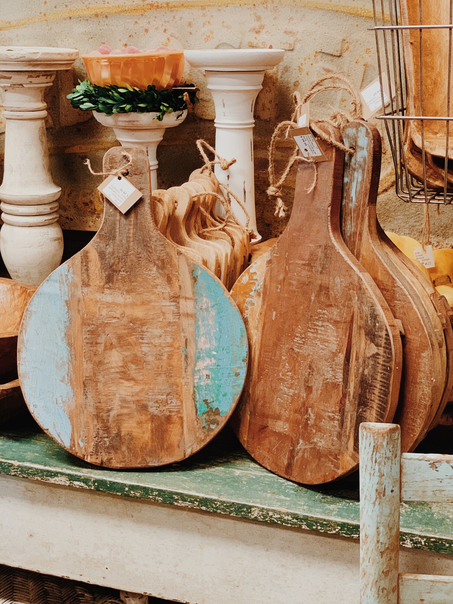 These round, wooden cutting boards feature distressed pops of color! They measure 17 inches long by 12 inches wide.